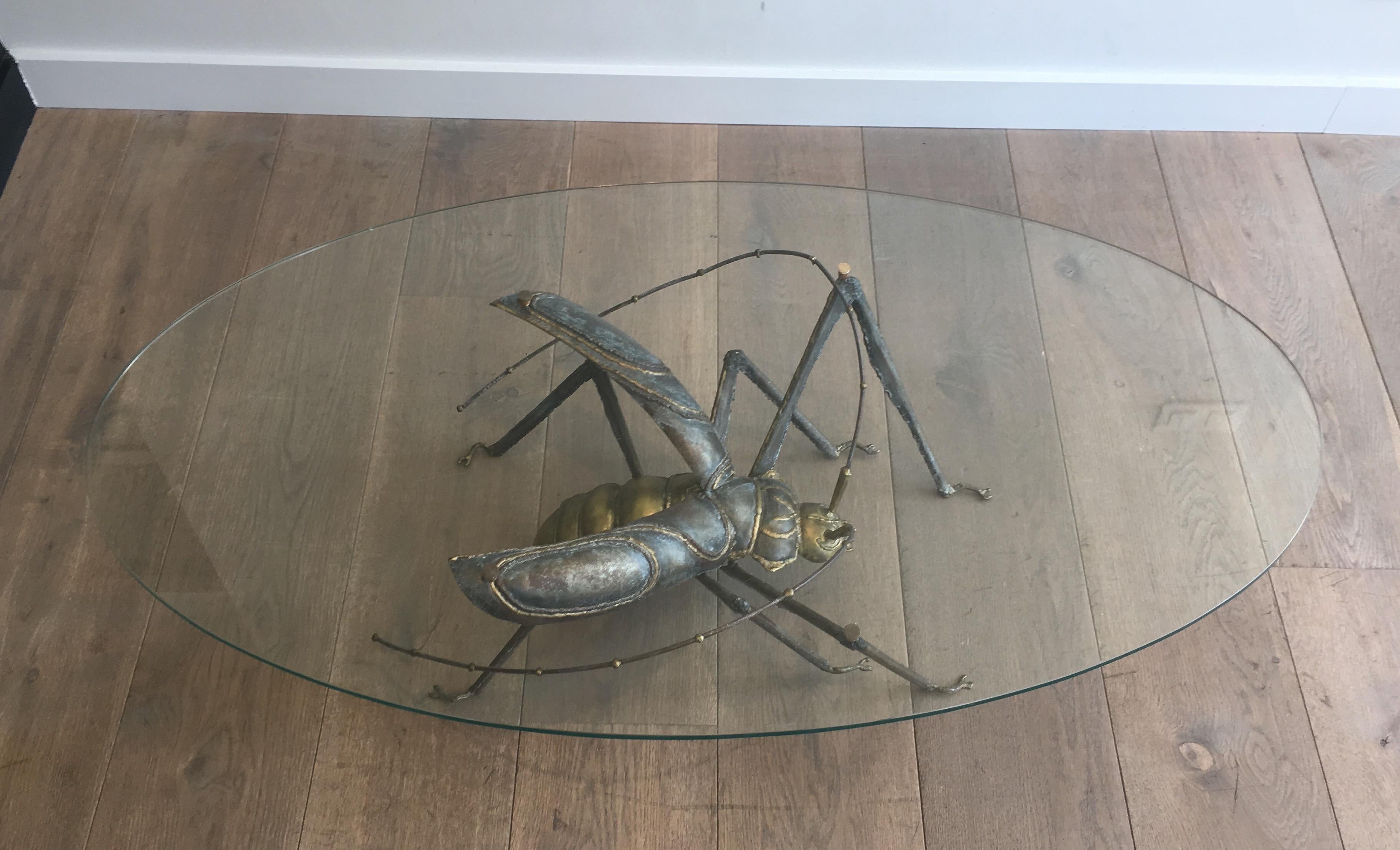 This rare coffee table is made of brass and wrought iron. This is a very interesting work showing a grasshopper. This table is in the style of famous French designer Jacques Duval Brasseurr, circa 1970.