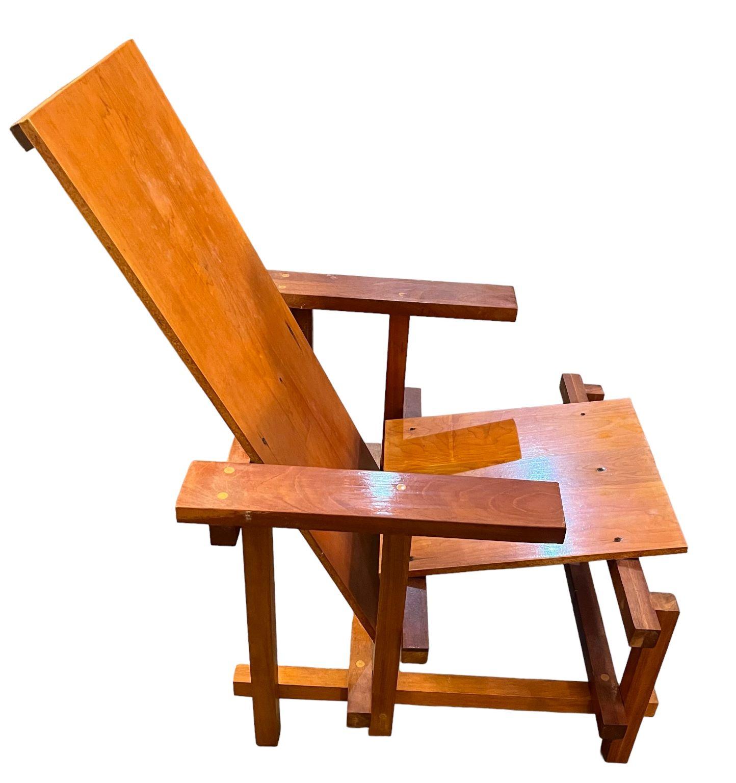 Iconic chair in the style of Dutch artist Gerrit Rietveld. The chair is constructed of maple veneer and solid mahogany. Manufacturer is unknown however all the joints and overall craftsmanship look very professional. In good vintage condition. Some