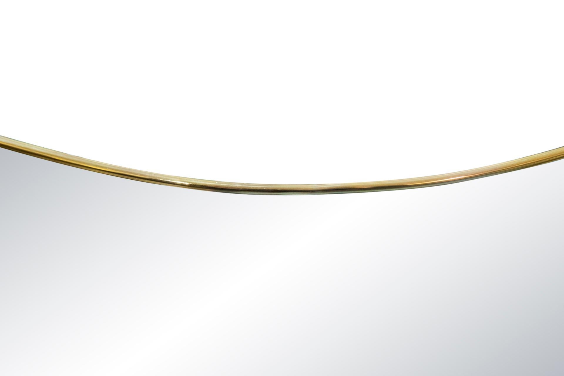 In the style of Gio Ponti, 
Mirror, gilt brass,
Italy, circa 2000.

Measures: Height 150 cm, width 69 cm, depth 3 cm.