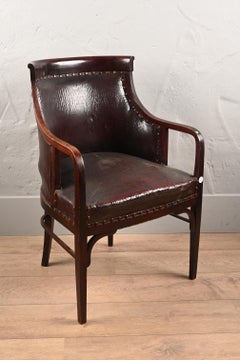 in the style of J. & J. Kohn, armchair with wide seat covered in leather.