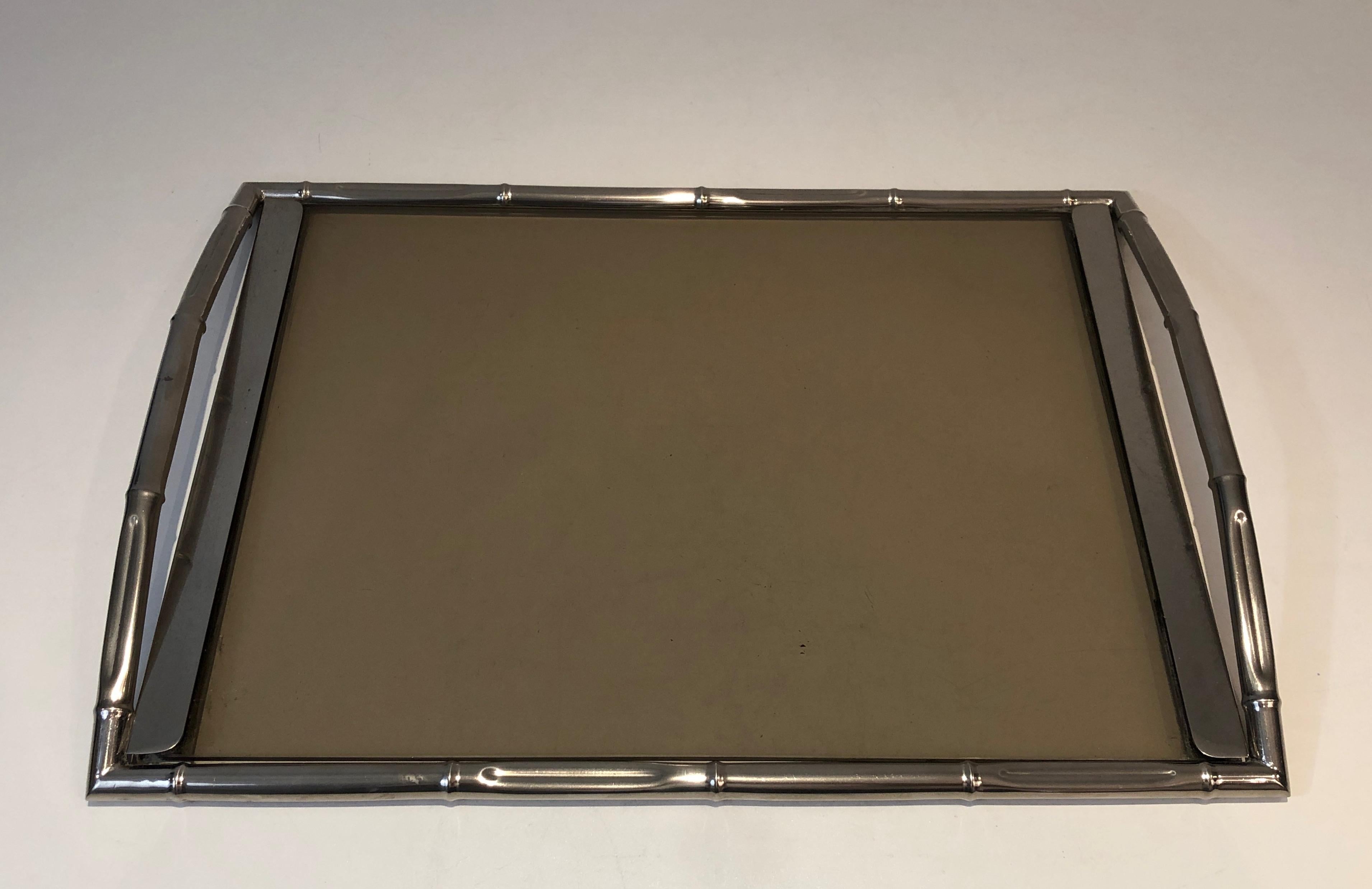This faux-bamboo tray is made of chrome with smoked glass. This is a French work, in the style of famous French designer Jacques Adnet, circa 1970.