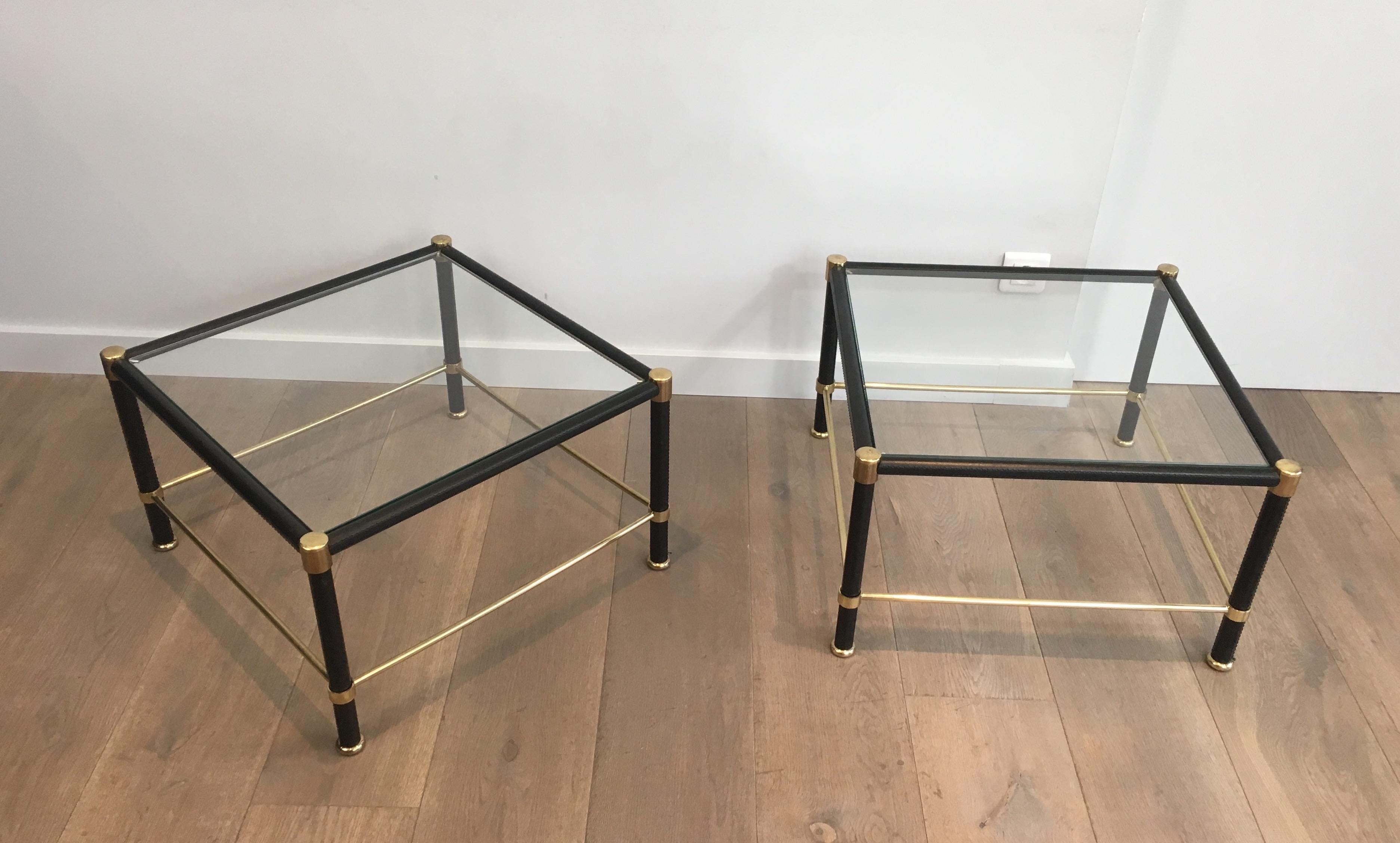 This very nice pair of square side tables is made of brass and black leather. This is a French work, in the style of famous designer Jacques Adnet, circa 1970.