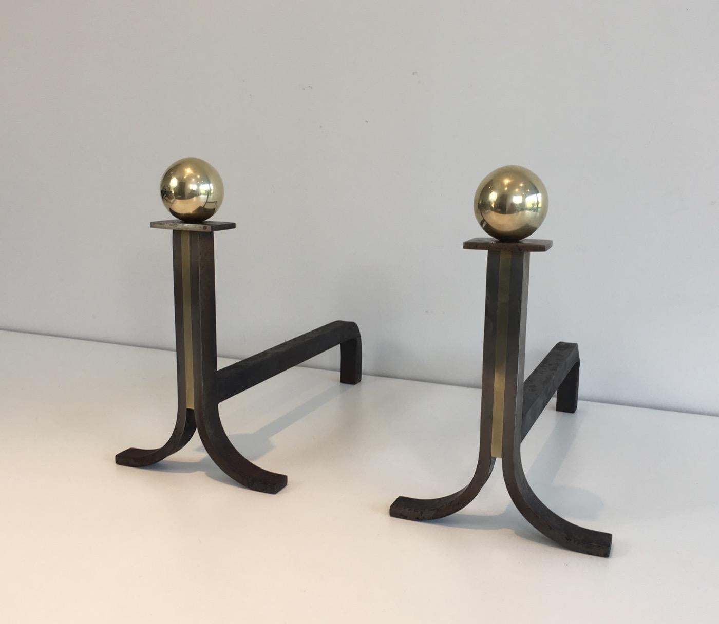 This pair of modernist andirons is made of steel, iron and brass, French, circa 1940.