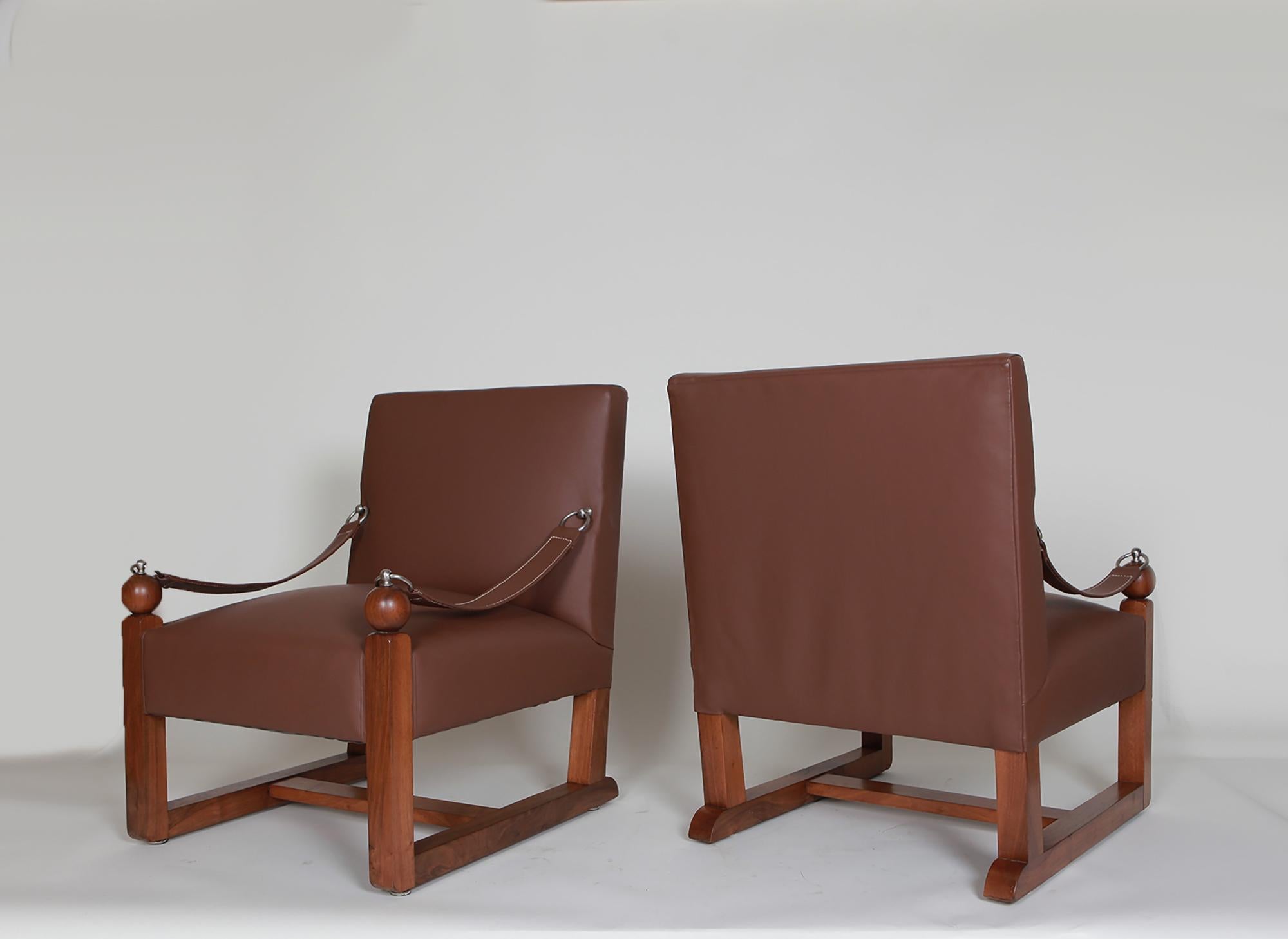 In the style of Jacques Adnet -Twin chairs, circa 1950.
Wood and leather.
32.5 H x 24 W x 26.8 D inches.
   