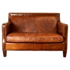 In the style of Jean Michel Franck, leather sofa, circa 1930, France.