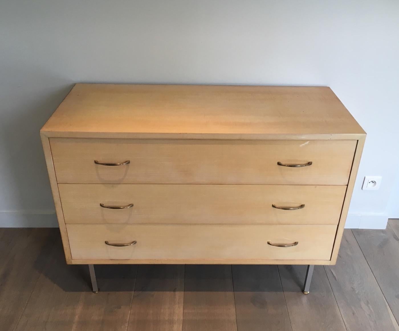 This rare and nice commode is made of Sycamore on a brushed steel base. The inside of the drawers of this chest is made of blond mahogany. This is a nice and simple design in the style of famous designer Florence Knoll. Circa 1970.