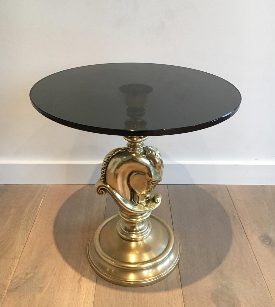 This small round occasional table is made of brass with a thick smoked glass top. This gueridon is a French work, in the style of famous maker Maison Charles, circa 1960.