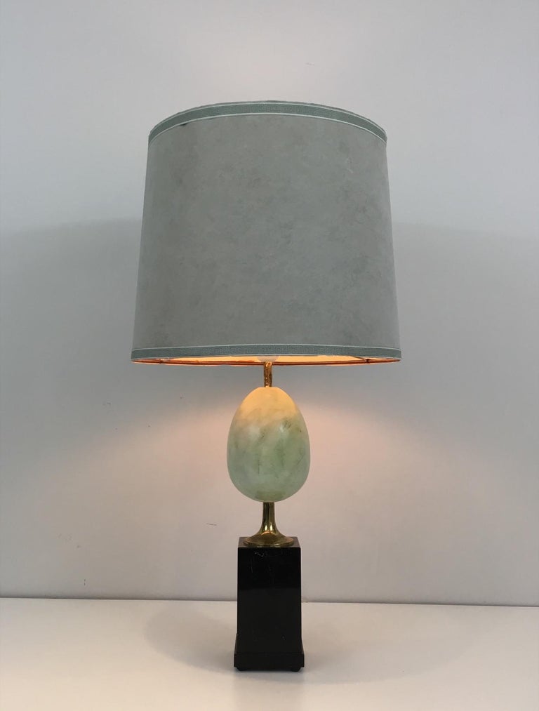 This very elegant table lamp is made of a painted ostrich egg with brass element on a black marble base.
This is a work in the style of famous French designer Maison Charles, circa 1970.