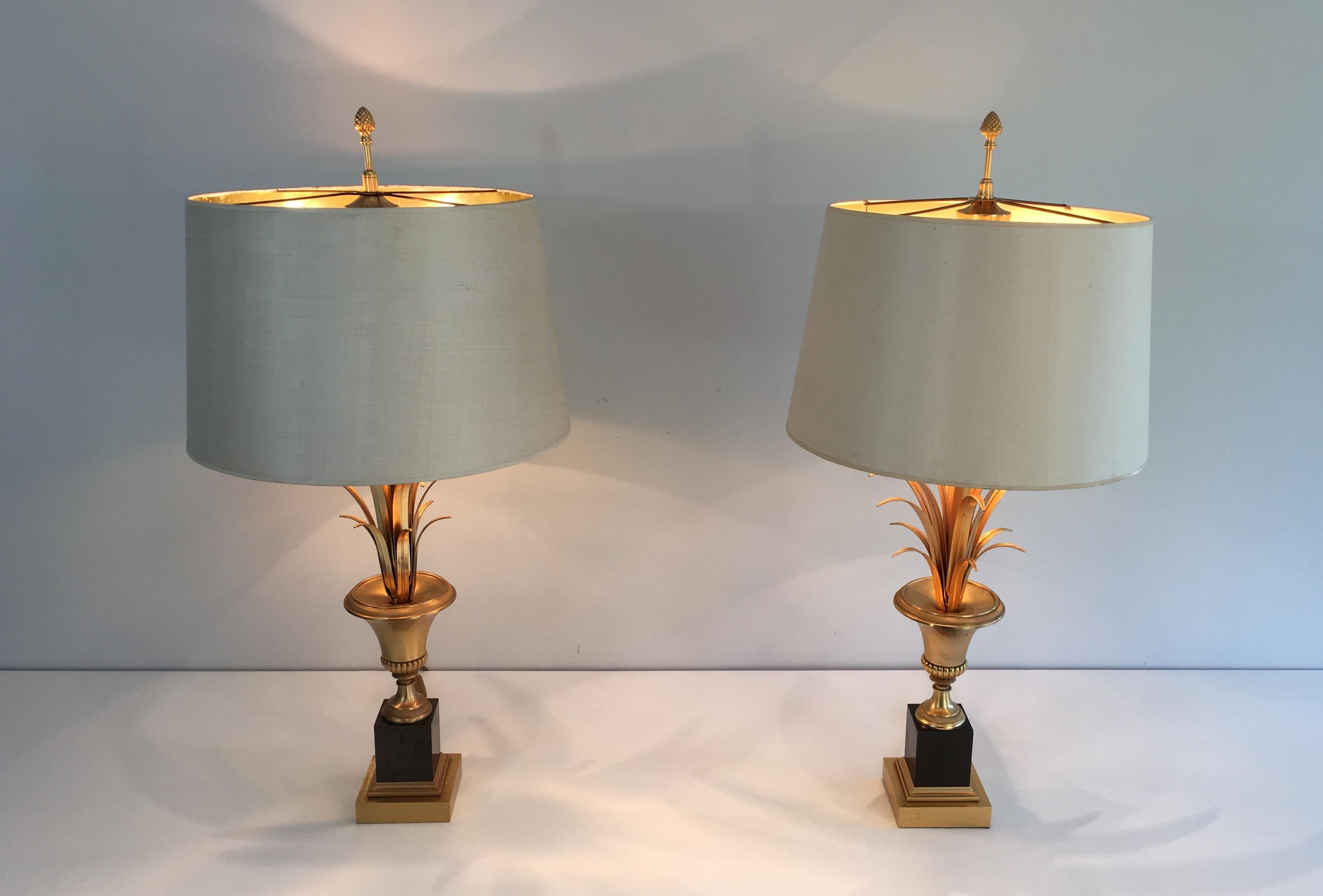 In the style of Maison Charles. Elegant pair of black lacquered and gold gilt nickel palm tree table lamps. French, circa 1970.