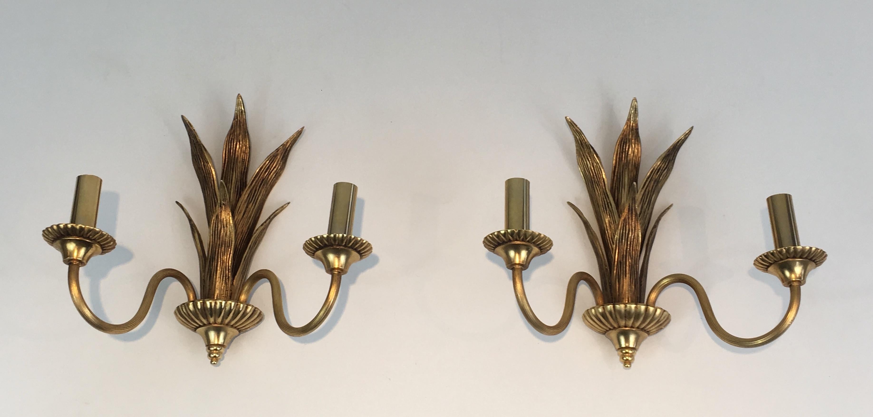 This pair of sconces is made of brass and bronze palm tree. These wall lights are very decorative and the quality is really good. This is a French work in the style of famous French designer Maison Charles, circa 1970.