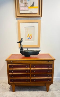 In the style of Maxime Old, small wood and leather chest of drawers.