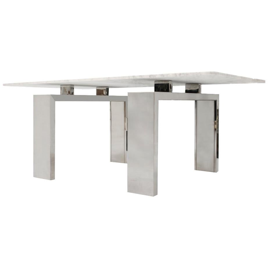 Dining table designed by L.A. Studio composed of two sculptural feet of the 1970s in steel and made in Carrara marble, France.
