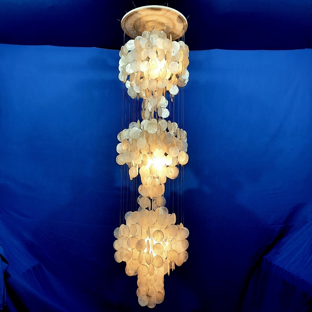 Verner Panton is the designer of the serie Fun shell that started in 1964. It was edited by Verpan and is still in production this days. 
This version is earlier than Panton's design. 
Mother of pearl and other shells have been used for decades in