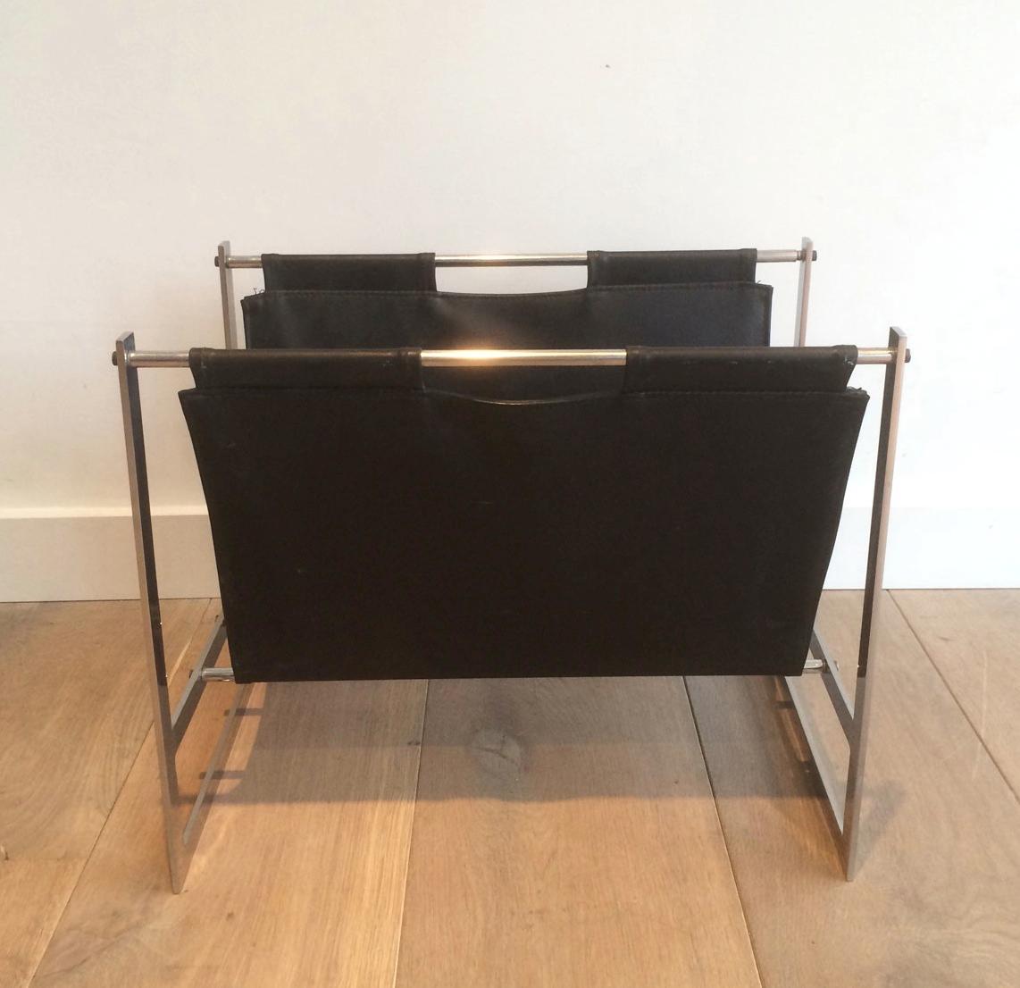 This interesting magazine rack is made of brushed steel and black leather. This is a work in the style of famous Danish designer Poul Kjaerholm, Denmark, circa 1970.