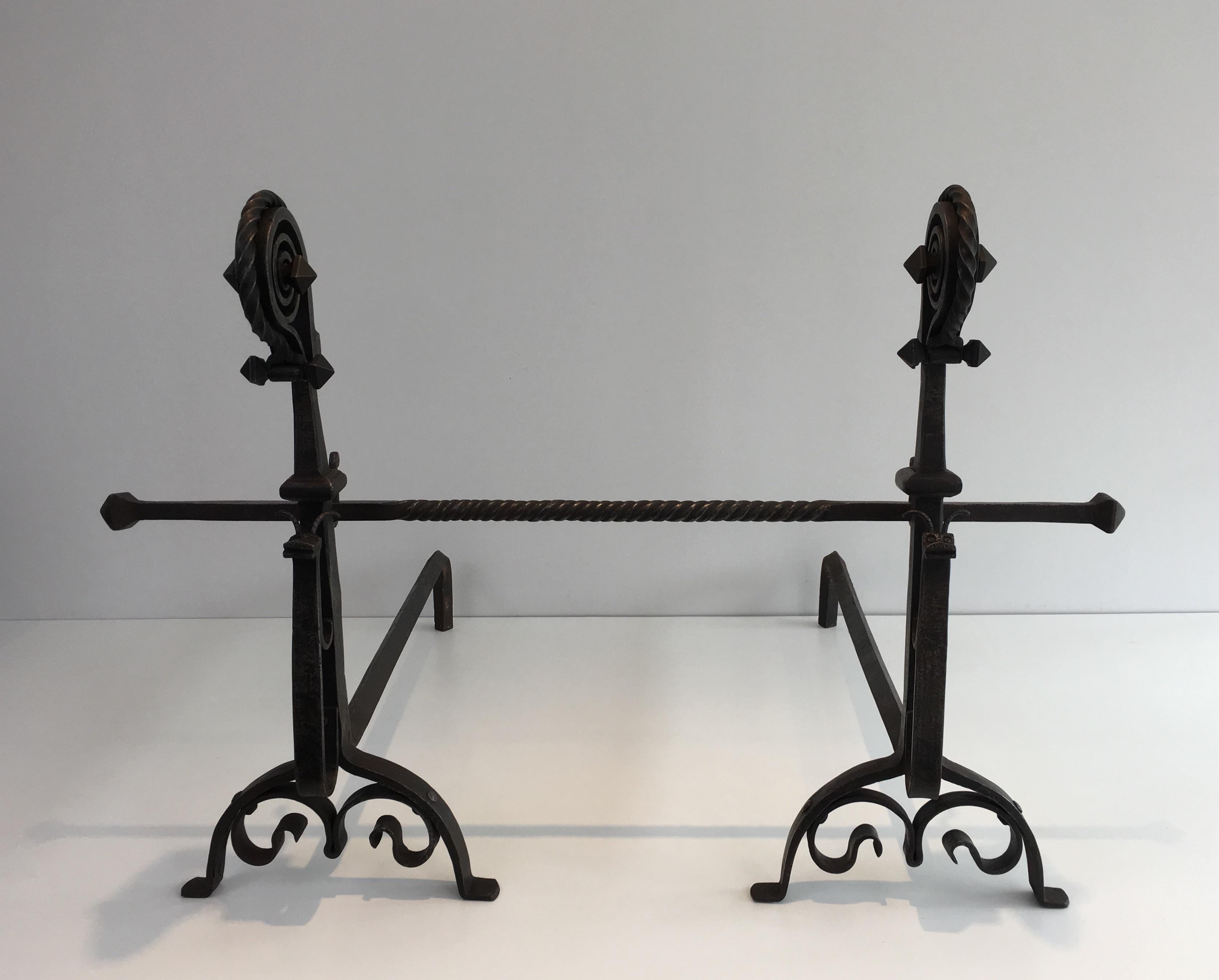This exceptional pair of andirons is made of a hammered wrought iron. This beautiful work represents 