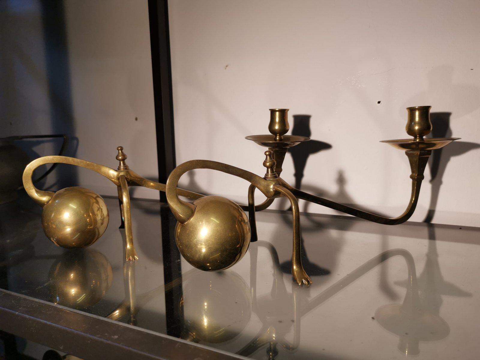 In the style of W A S Benson. 
A pair of brass Arts & Crafts counter-weighted piano candle holders.
These are Spanish and very much in the style of W A S Benson.
Originally designed to sit on top of a piano leaning over the edge to illuminate the