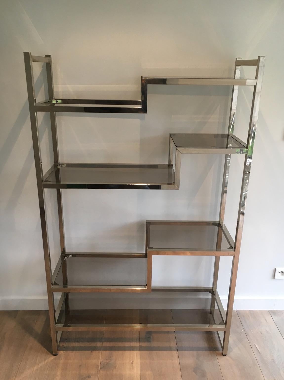 This design shelves unit is made of chrome and smoked glass tops. This is a French work in the style of famous designer Willy Rizzo, circa 1970.