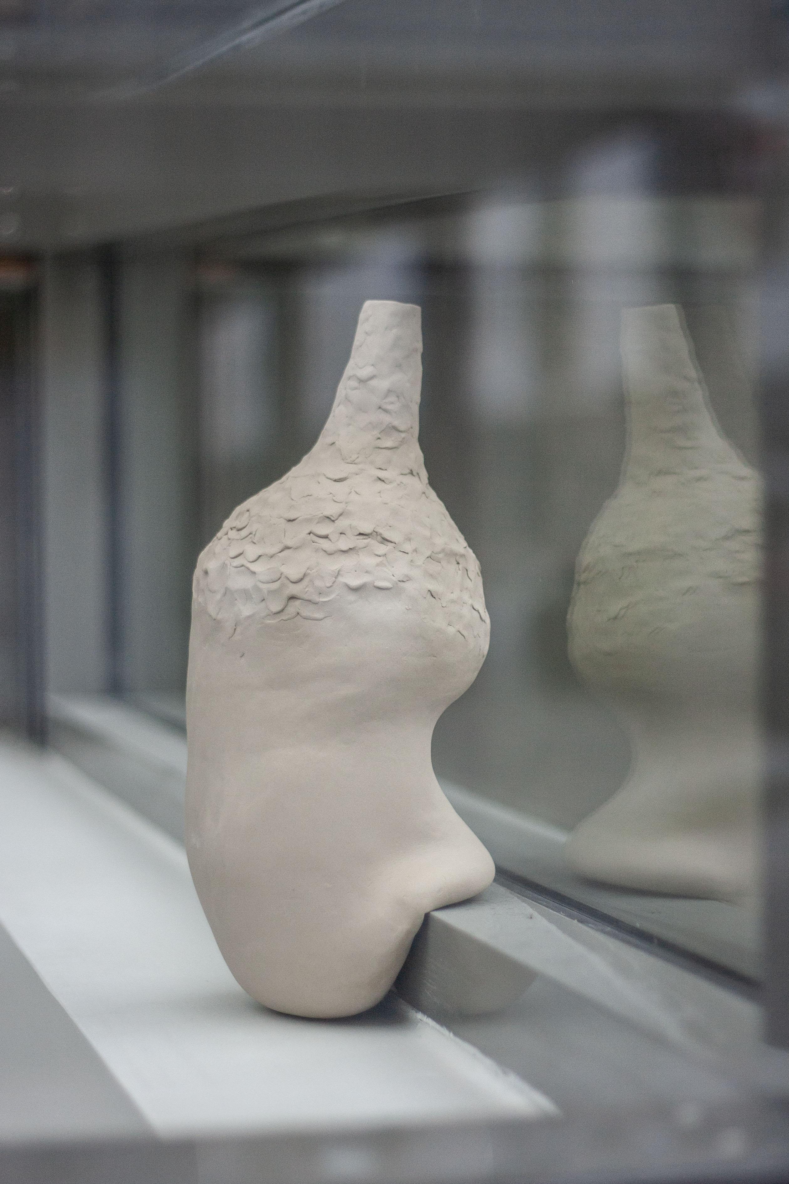 In The Windowsill I Decorative Ceramic Vase by Lillian Tørlen
Unique Piece.
Dimensions: D 16 x W 16 x H 34,5 cm. 
Materials: Ceramic. 

The exhibition Levels of Attachment and Belonging consists of a series of ceramic vases pressed, squeezed, and