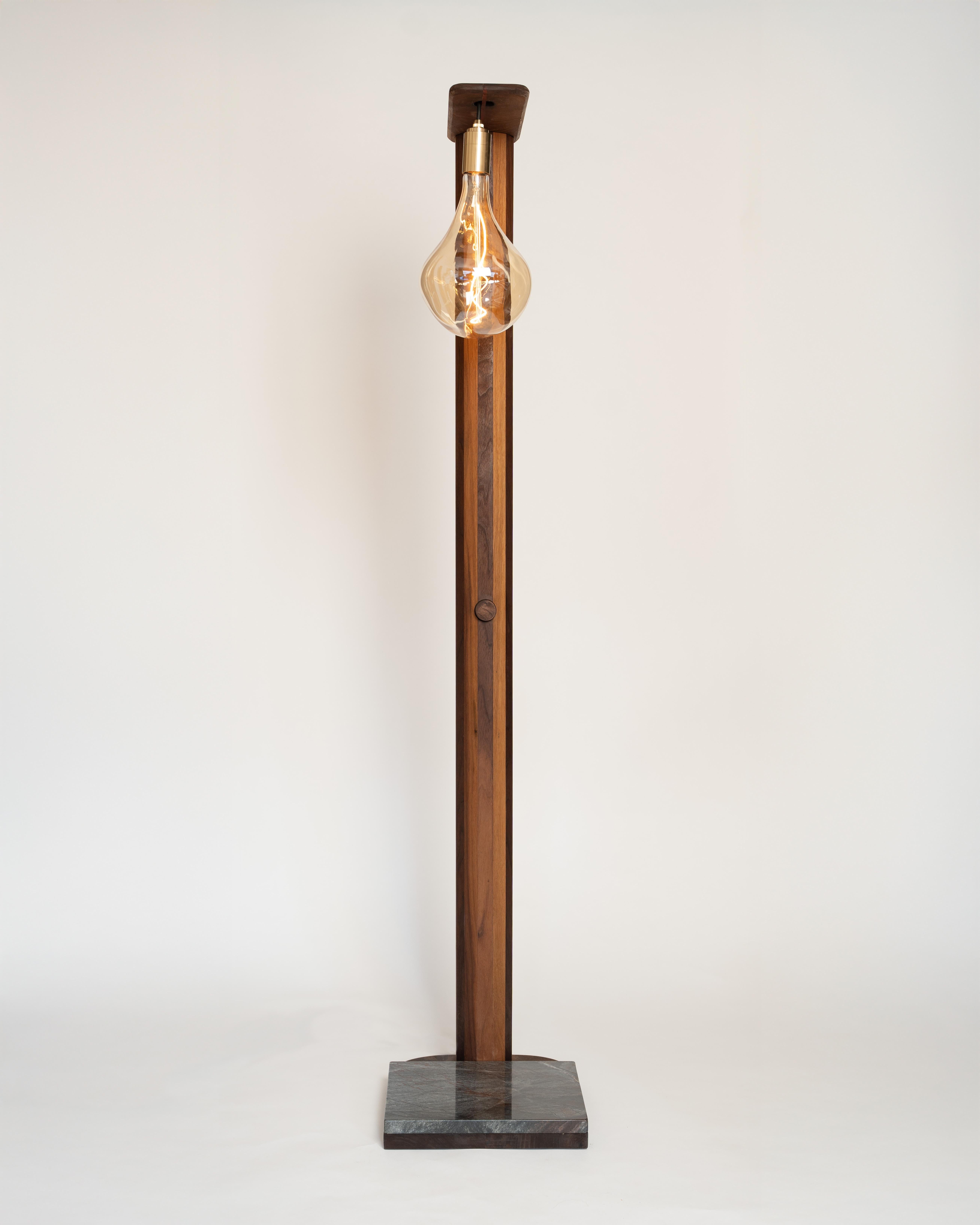 Crafted from solid walnut and grounded by an Avocatus stone base, this floor lamp is a celebration of nature’s raw beauty. A Tala pendant and bulb provide warm, high-quality illumination, while the dimmable feature and adjustable height allow you to