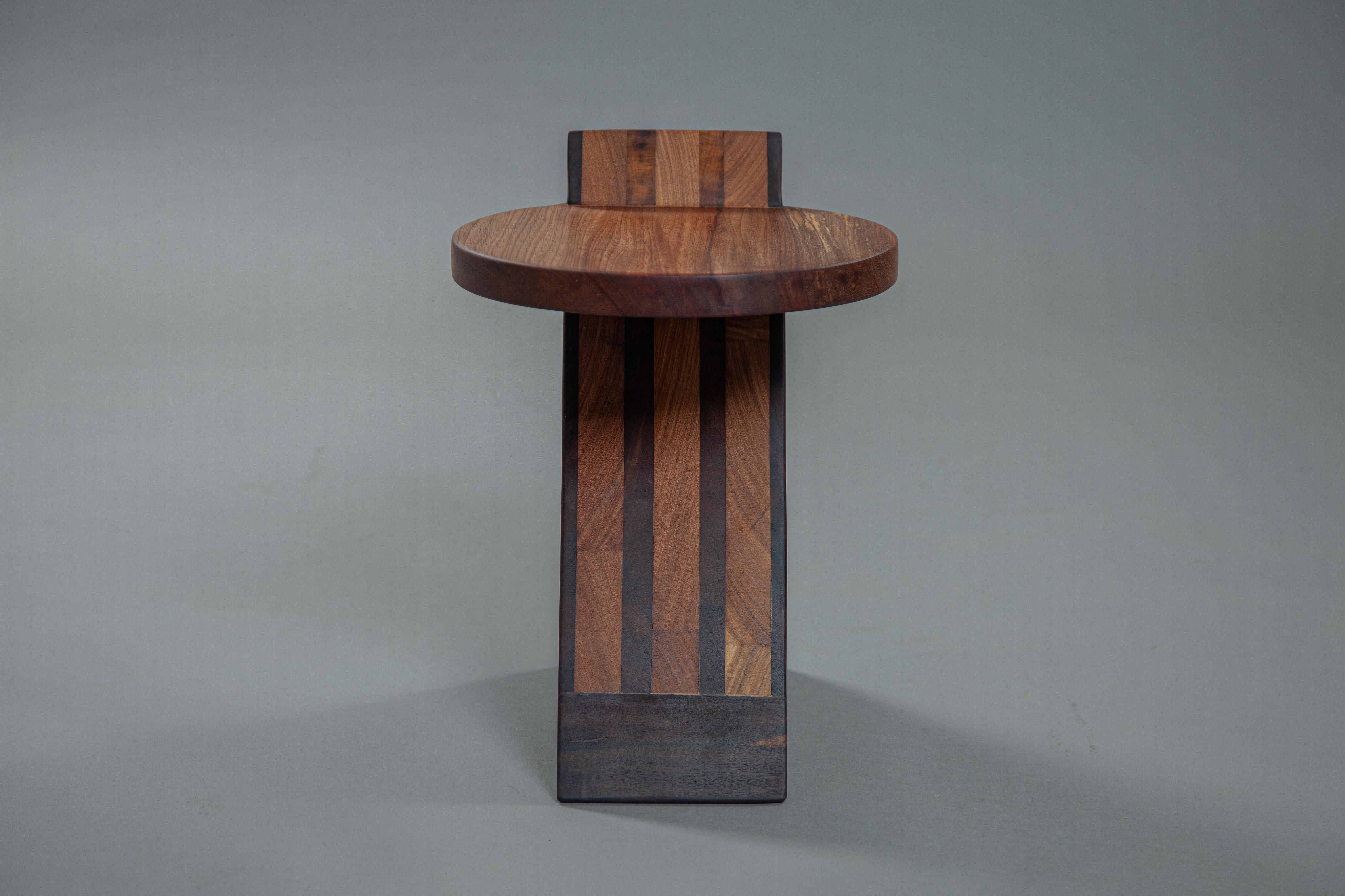 The Inácio stool plays with geometric shapes, aiming to create a sense of movement and fluidity. It is made entirely from leftover solid wood from other projects, which would typically be discarded.90