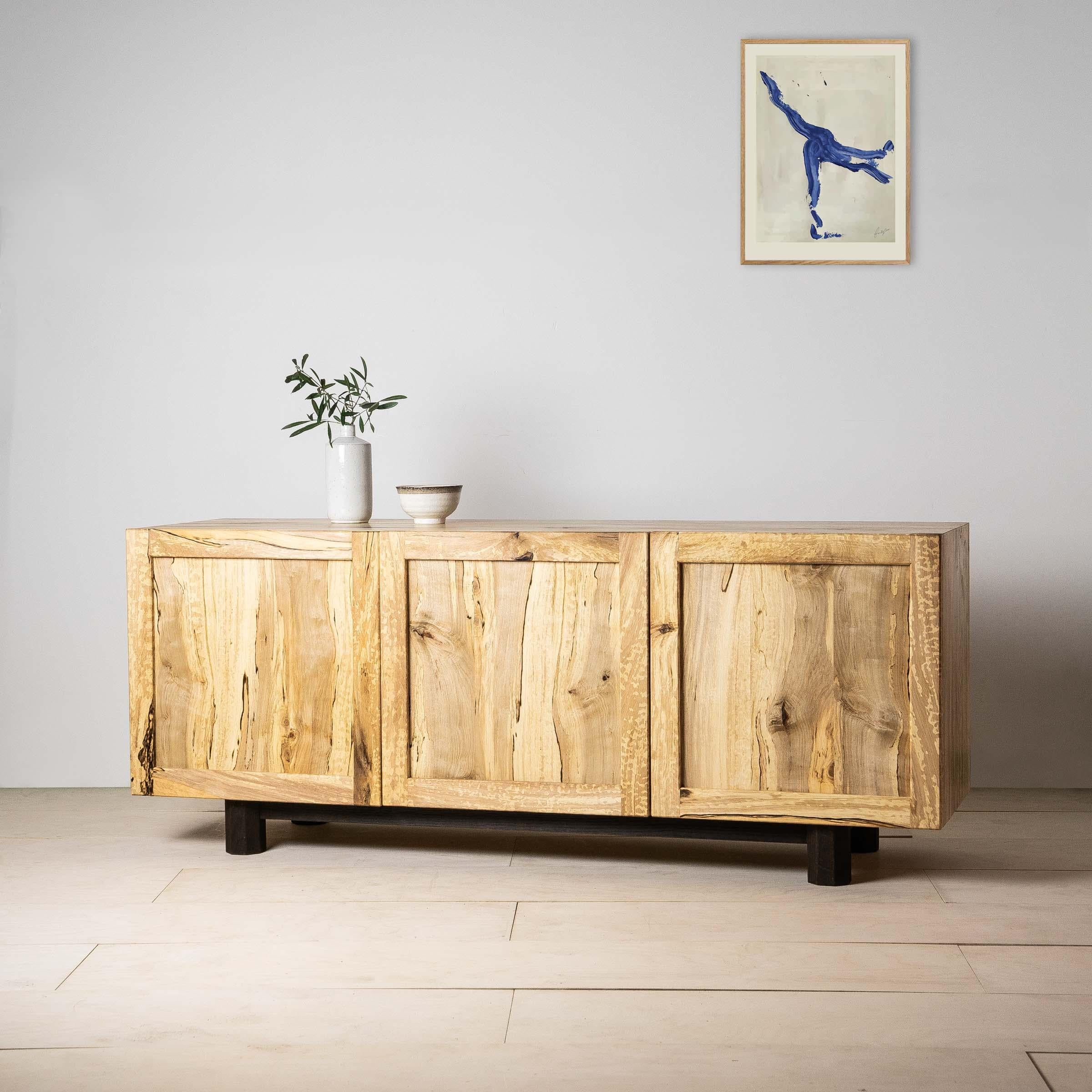 The Inari media cabinet is a celebration of spalted hornbeam, a rare native timber with intricate natural marbling formed by funghi penetrating the tree as it grew.

The cabinet features three drop-down doors with a panel and frame construction,