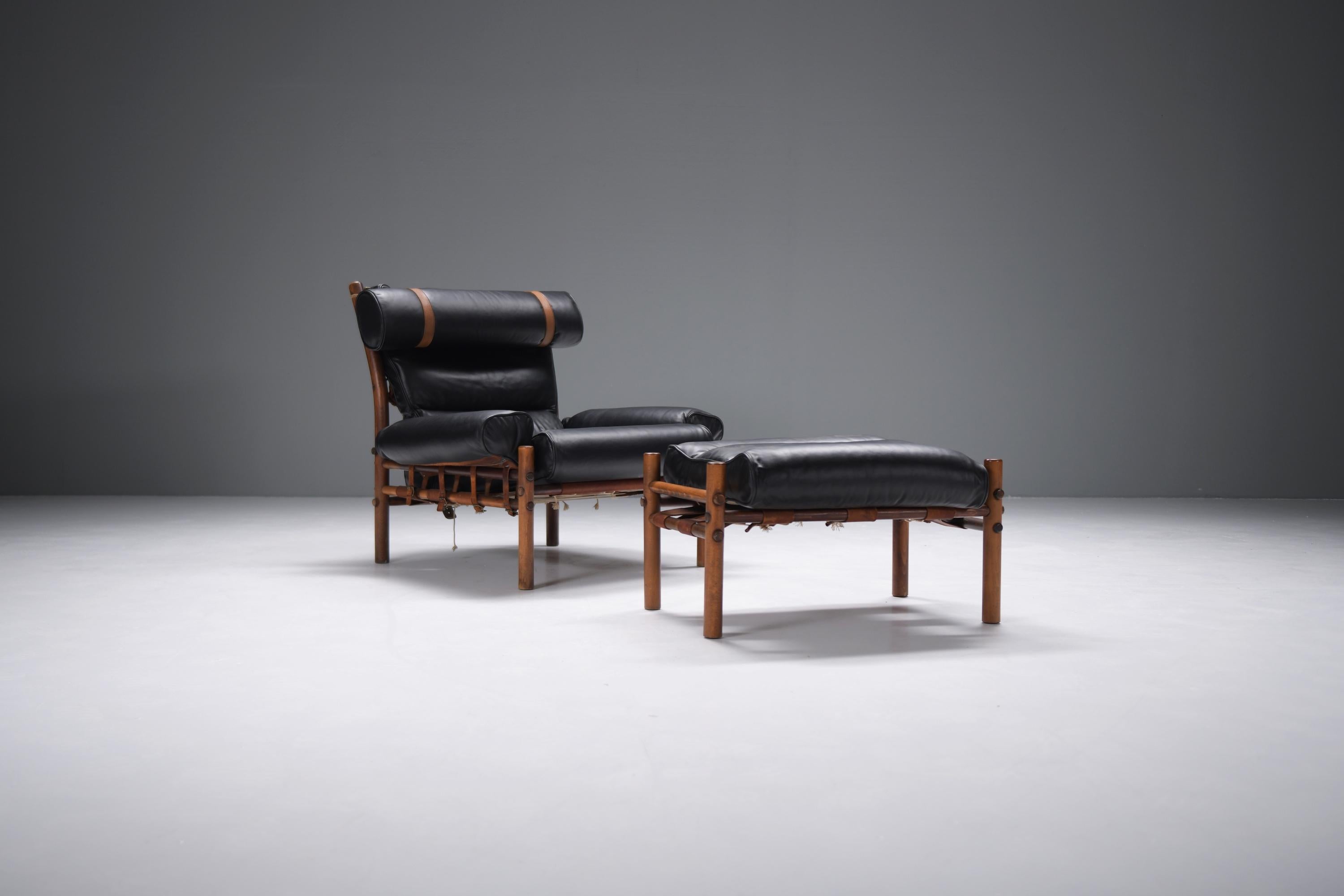 Stunning Vintage Inca lounge chair with ottoman in new black analine leather. Signed.
Designed by  Arne Norell for Norell Möbel AB Aneby, Sweden 1960s

After the “Safari Chair”, Arne Norell turned his attention to crafting a chair with the same