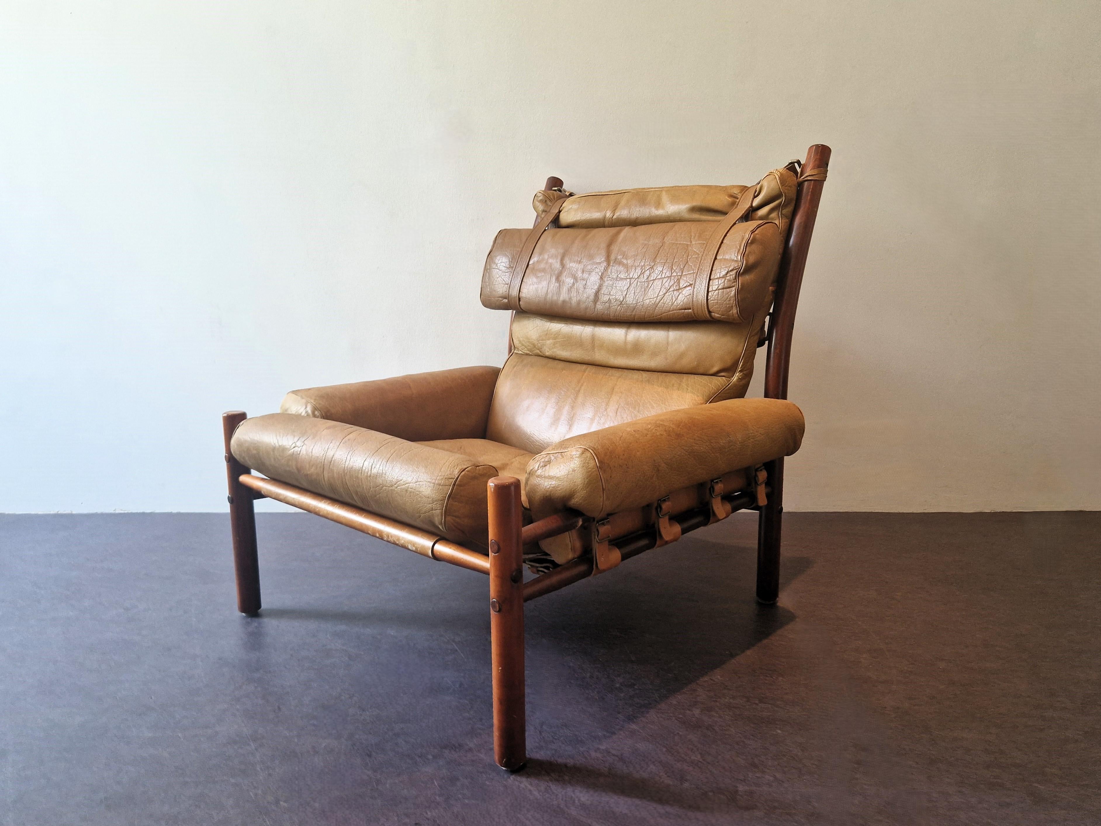 This very comfortable lounge chair, model Inca, was designed by Arne Norell in the 1960's in Sweden. It is made out of thick light brown leather, that has a beautiful patina. The visible (beech) frame and leather straps are very characteristic for