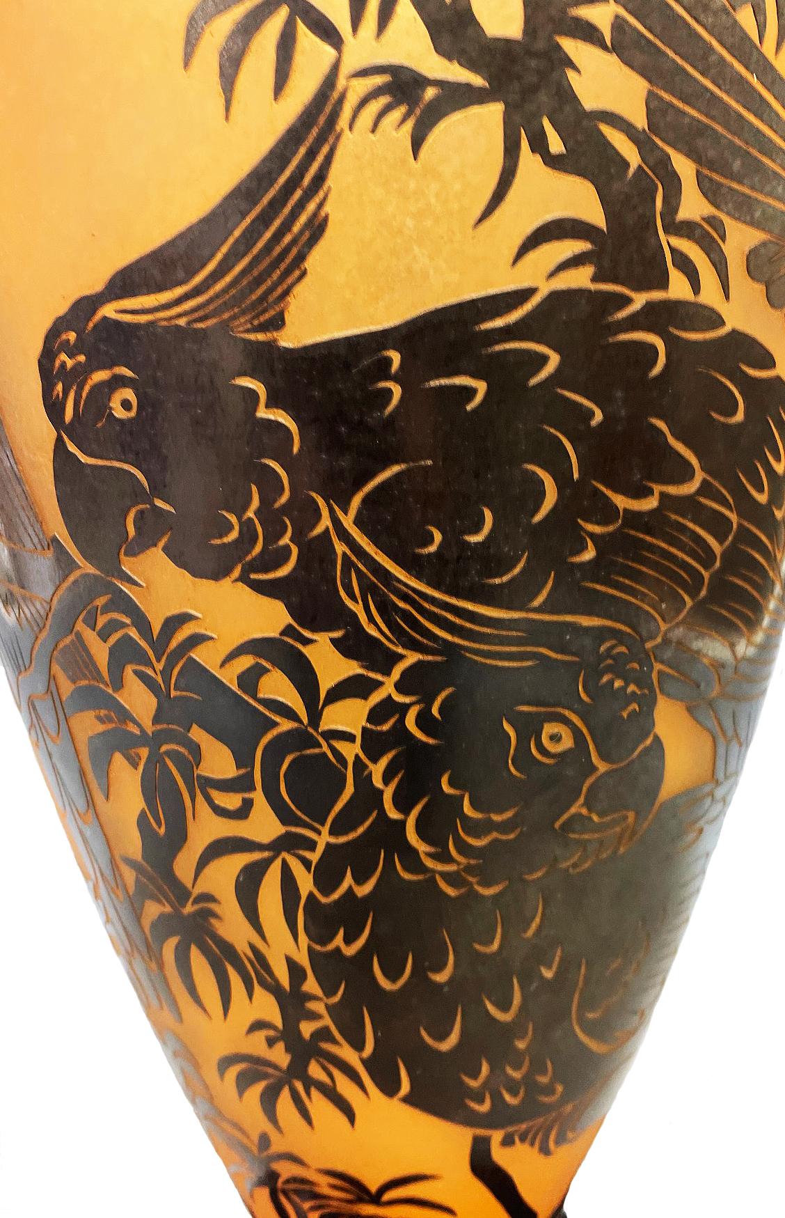 This cameo etched vase by Gary Genetti is incalmo and overlay blown glass. The original artwork is drawn, hand cut then pressure etched through layers of color to create the imagery. The piece consists of sections of layered colored glass partially