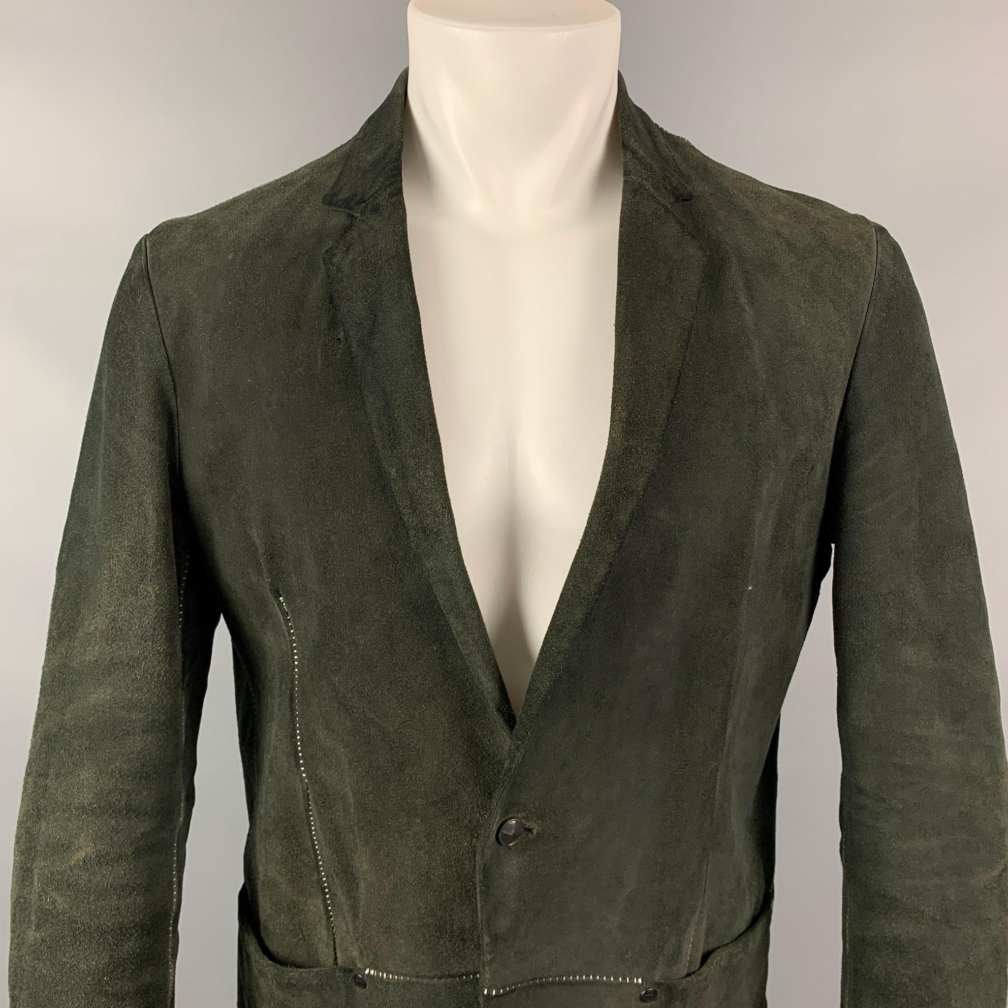 INCARNATION jacket comes in a forest green suede with a full liner featuring a notch lapel, contrast stitching, slit pockets, and a single button closure. Made in Italy.

Good Pre-Owned Condition.
Marked: M
Original Retail Price: