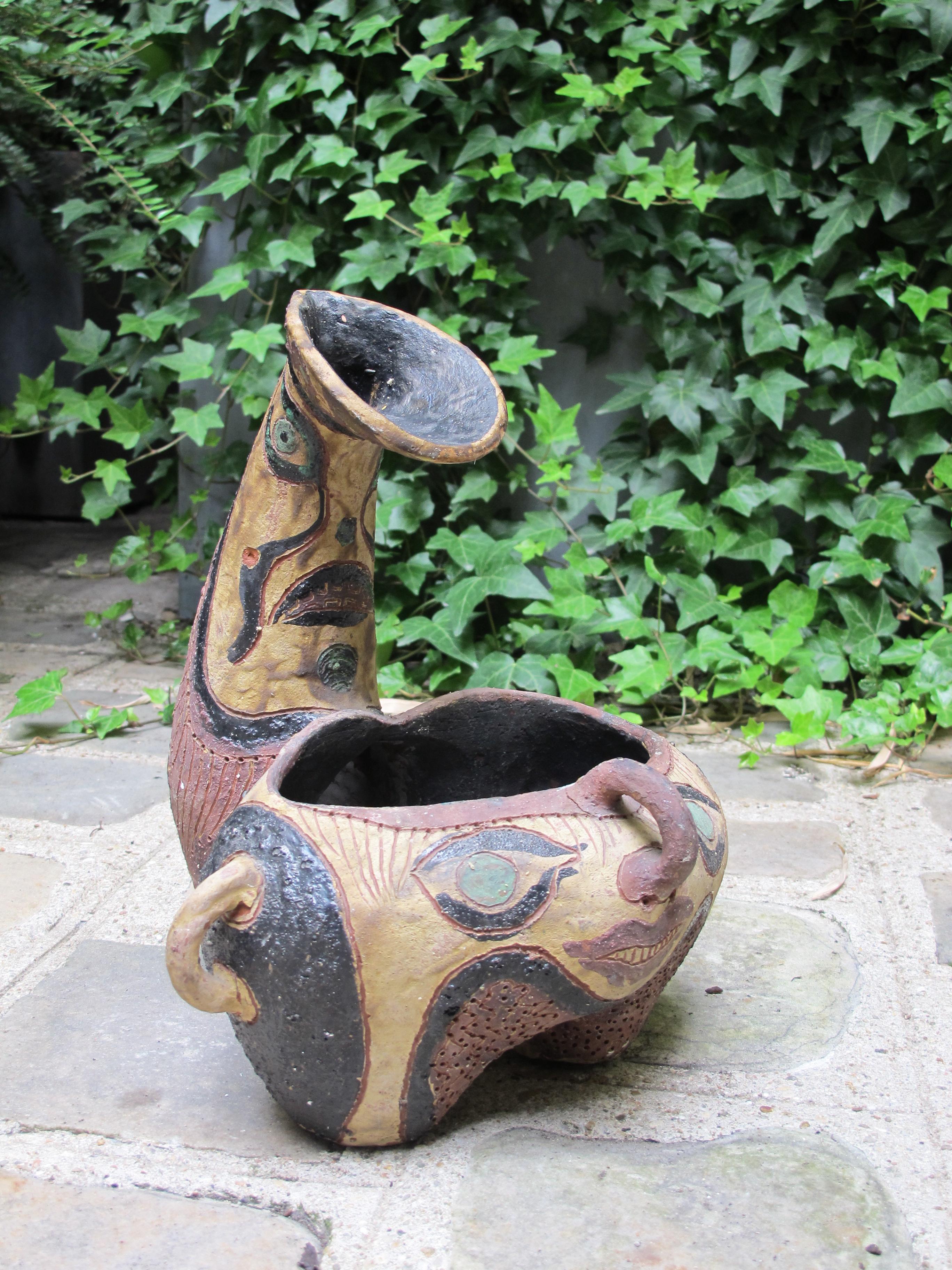 Incised and painted ceramic tripod zoomorphic vase.
  