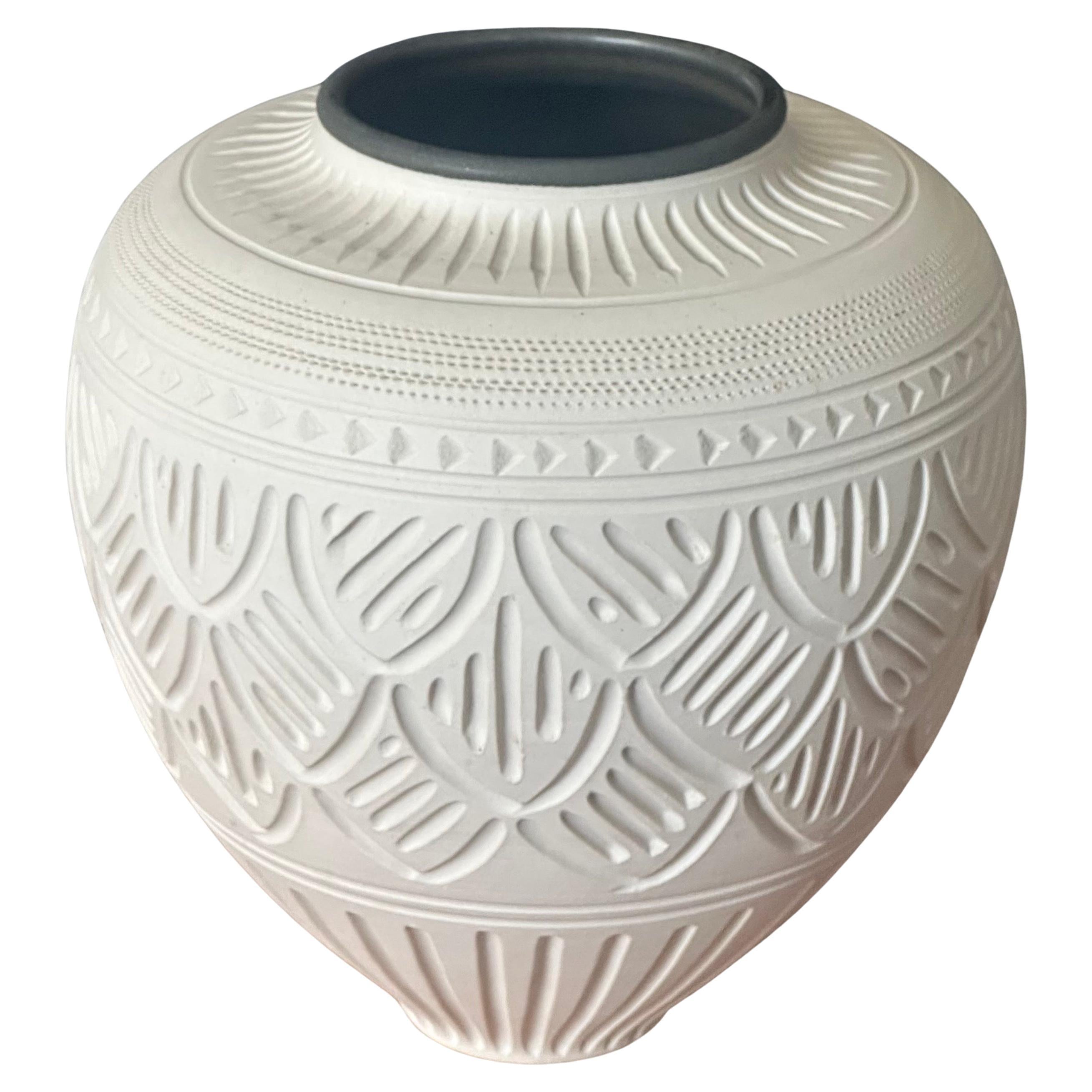 Simply gorgeous incised geometric design bisque porcelain vase by Nancy Smith, circa 1990s The vase has a black lining to the lip of the vase as is quite attractive.  It is in very good vintage condition with no chips or cracks and measures 7.75