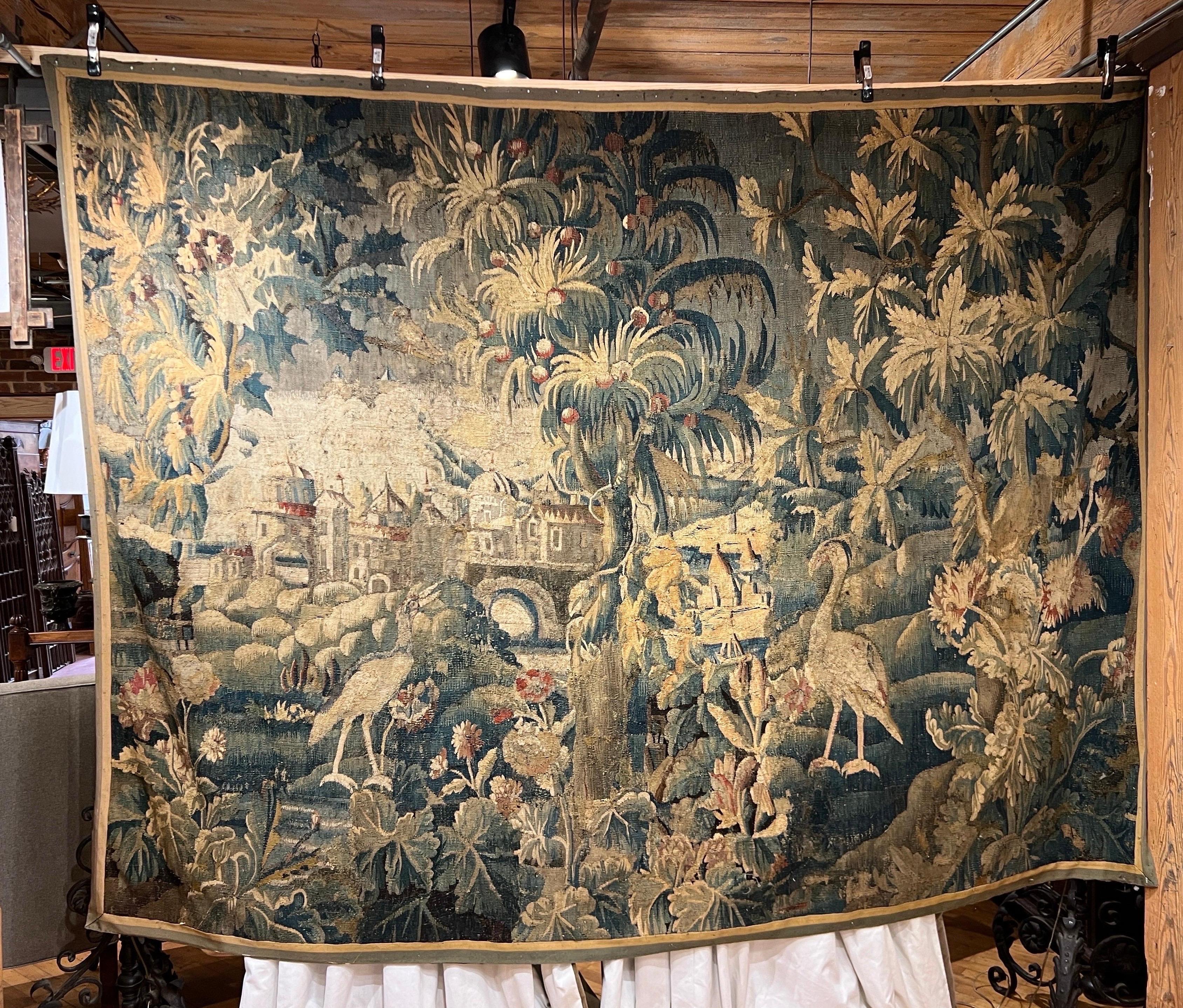 Incredible size and scale of this 17th-18th Century Aubusson tapestry city scape.  Beautifully done with cranes, foilage, trees, river and town in the background. As picturesque as it gets. The tapestry has had a backing added to help preserve this