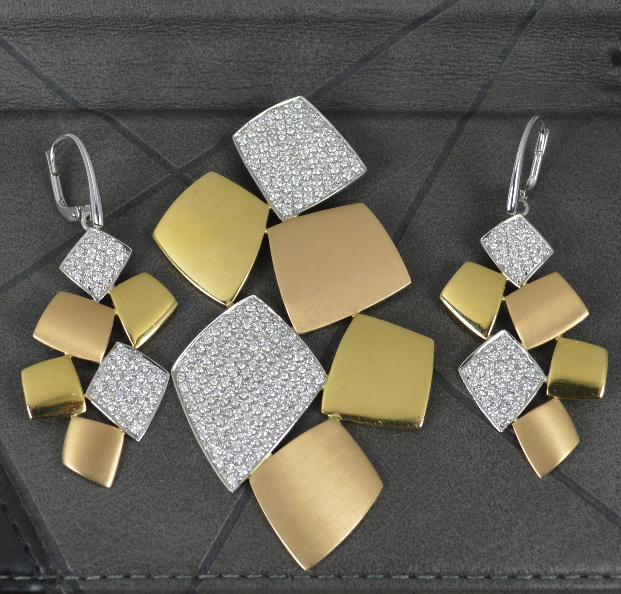 A superb 18 carat gold and diamond pendant and earrings suite.
Designed in 18ct gold. The two diamond sections in white gold, the two yellow gold panels with a polished finish and the rose gold panels with a brushed finish.
The earrings pave set