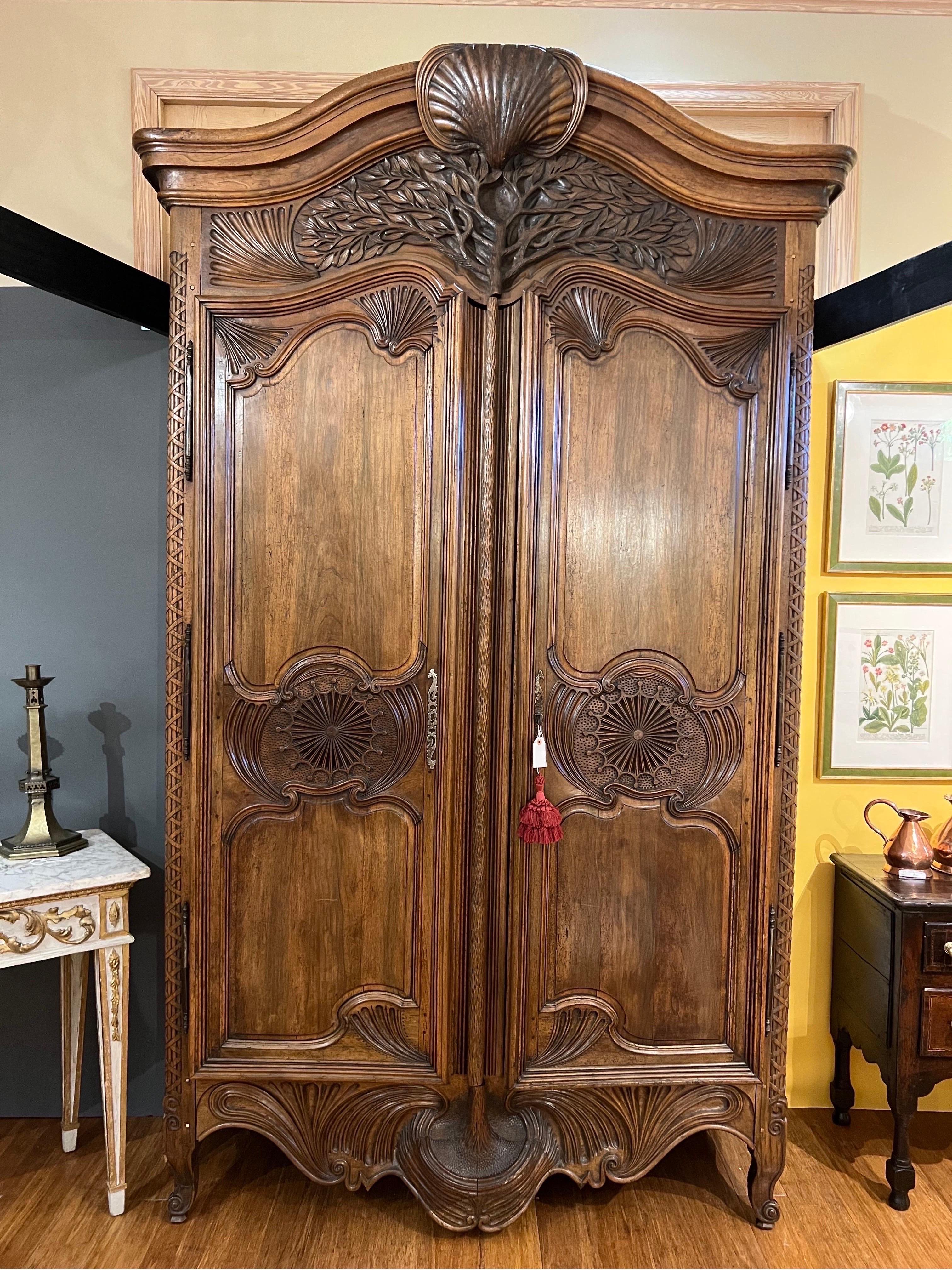 Simply the best armoire I have ever seen. This incredible work of art is from the 18th century and made in the south of France of walnut.

Clearly an important commission of the time, this armoire features the “tree of life” as the subject on the