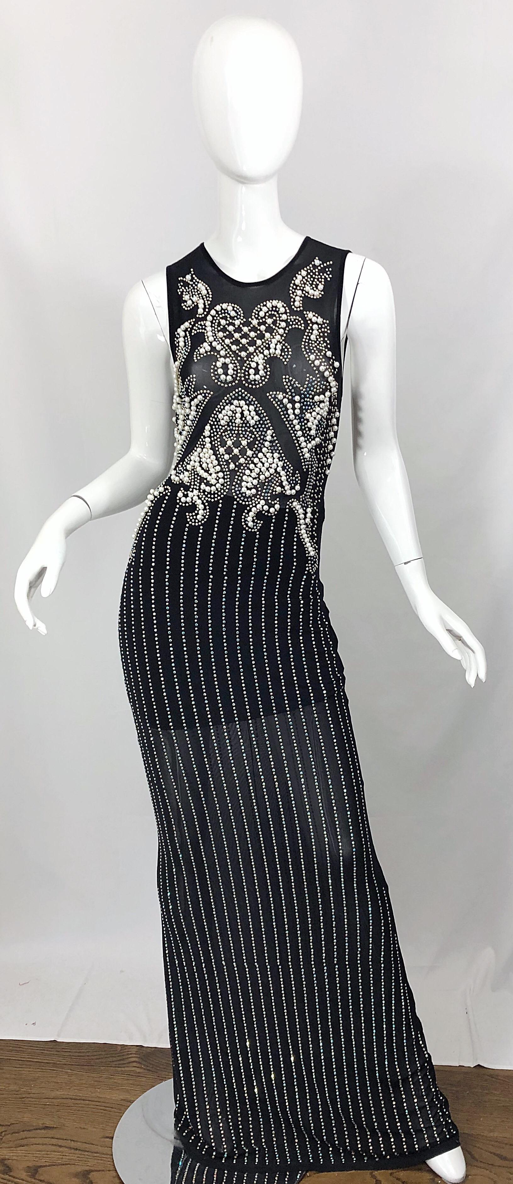Incredible hand made 1990s black semi-sheer mesh gown! Features thousands of hand-sewn pearls, studs, and rhinestones ( clear and light blue ) throughout. Meticulously placed stones cover the semi-sheer bust. Built-in 'mini skirt' lining covers the