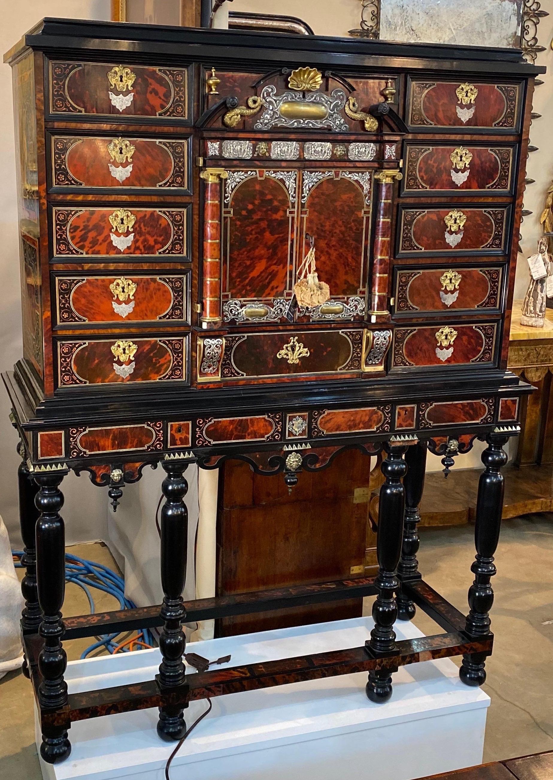 Incredible two piece 19th century Continental tortoiseshell and silver collectors cabinet on stand or vargueno. Likely Portuguese. 

Amazing quality with tortoiseshell drawers, tortoiseshell columns, bronze capitals, silver and bronze mounts,