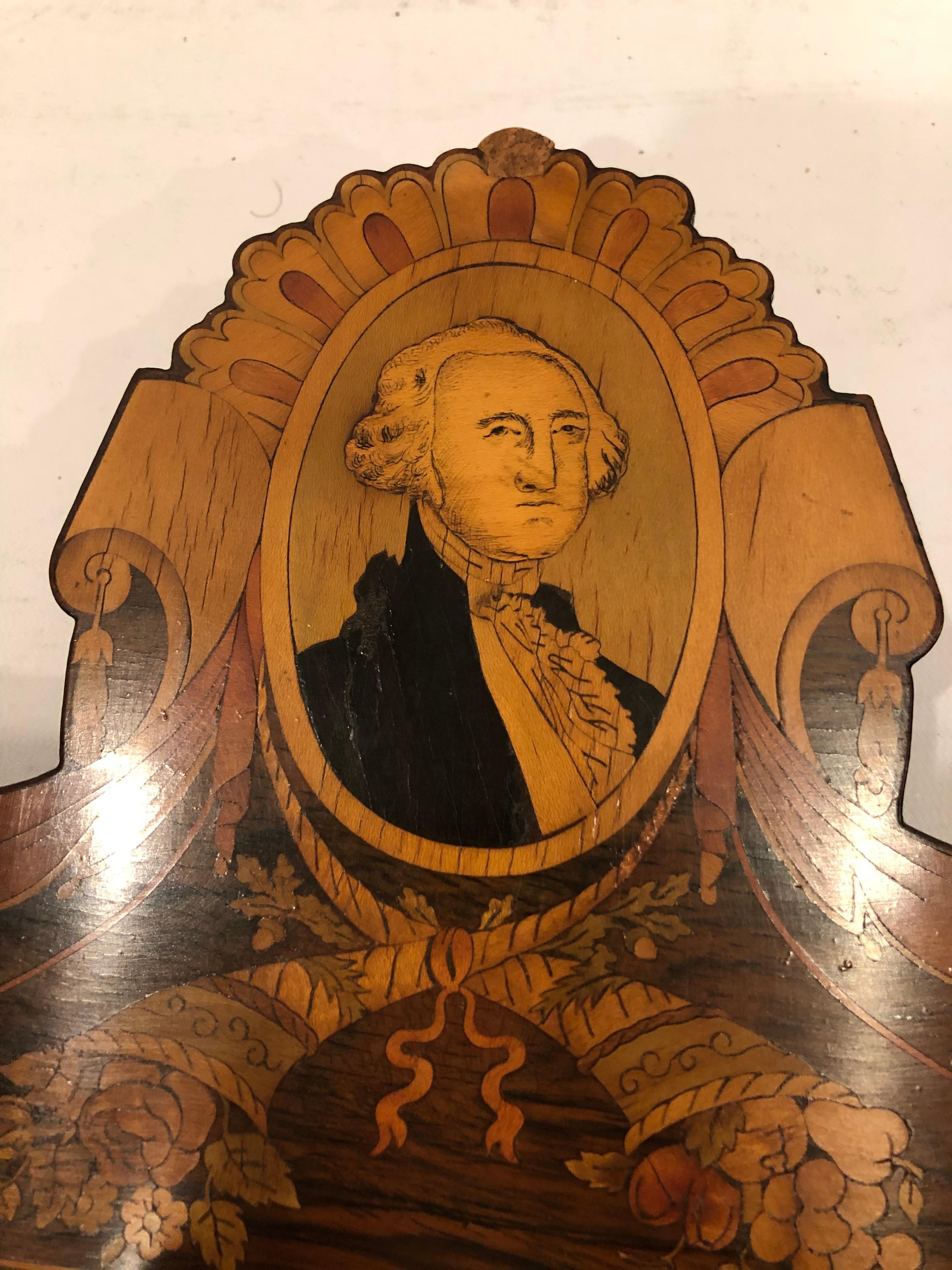 A rare one of a kind richly inlaid 19th century mixed wood mirror having striking portrait of George Washington at the top and marvelous scalloped shape.
Mirror measures 21.75 W x 25.5 H.