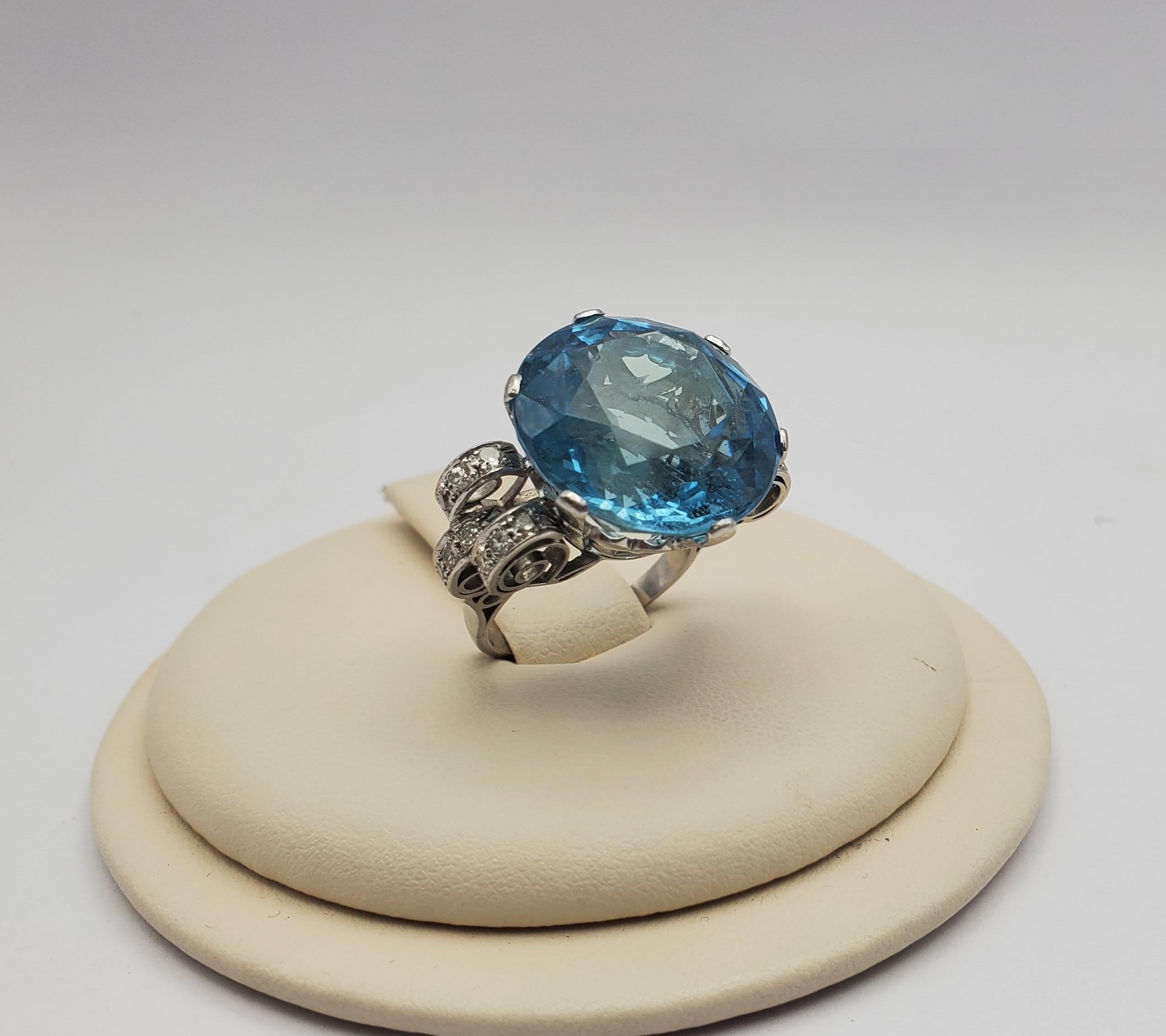 Stunning natural round aquamarine and diamond ring set in platinum. The center stone is a modified round brilliant cut allowing the saturated blue color of the aquamarine to show magnificently. The mounting is set with 0.36ctw of single cut round