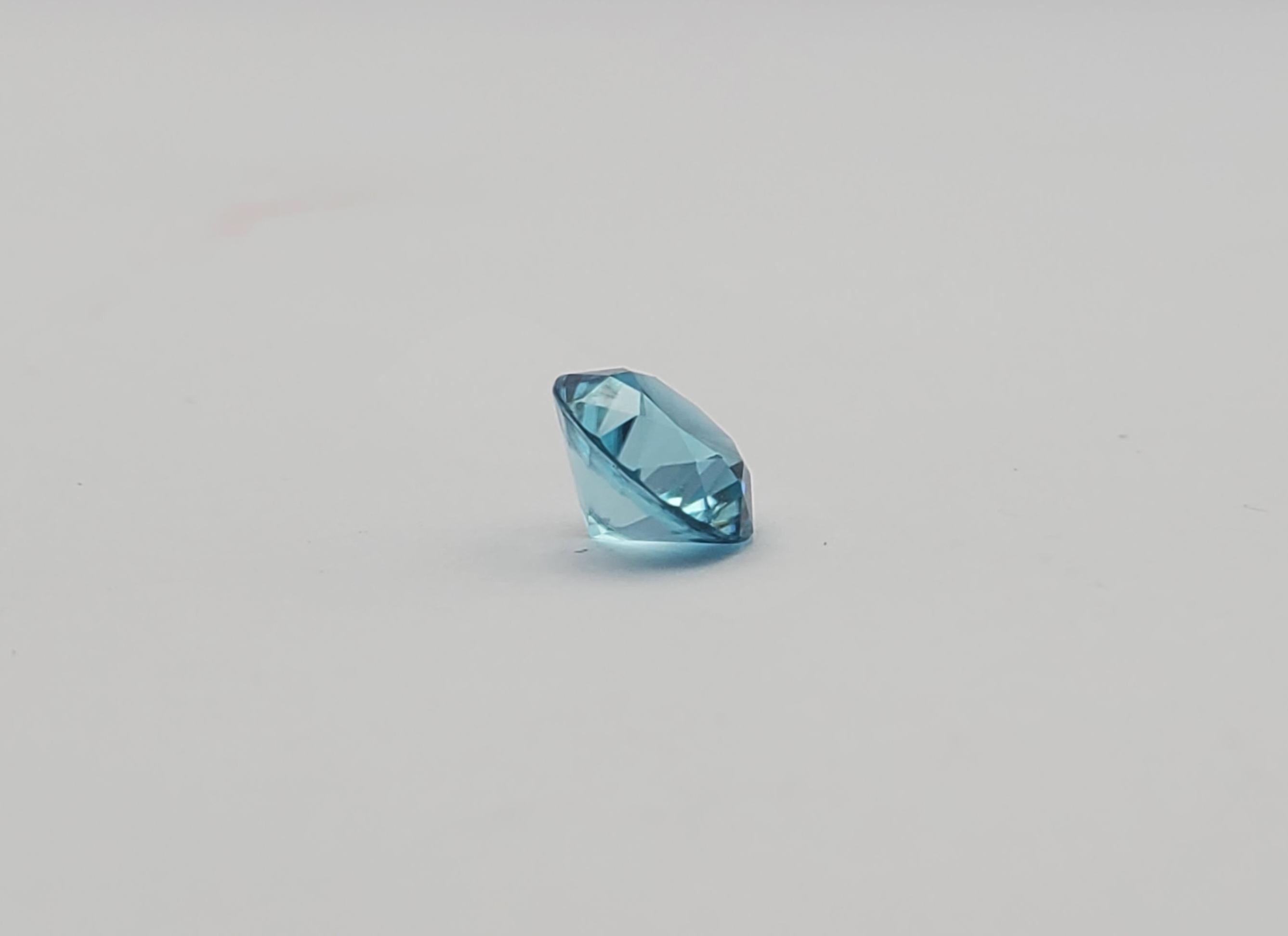 Stunning transparent 2.93ct round blue zircon. Its significant size and electric beauty will captivate the gaze of those who appreciate fine gems. The gemstone measures 8.02-8.04 x 5.20 mm, making a bold statement in any setting. The vibrant aqua