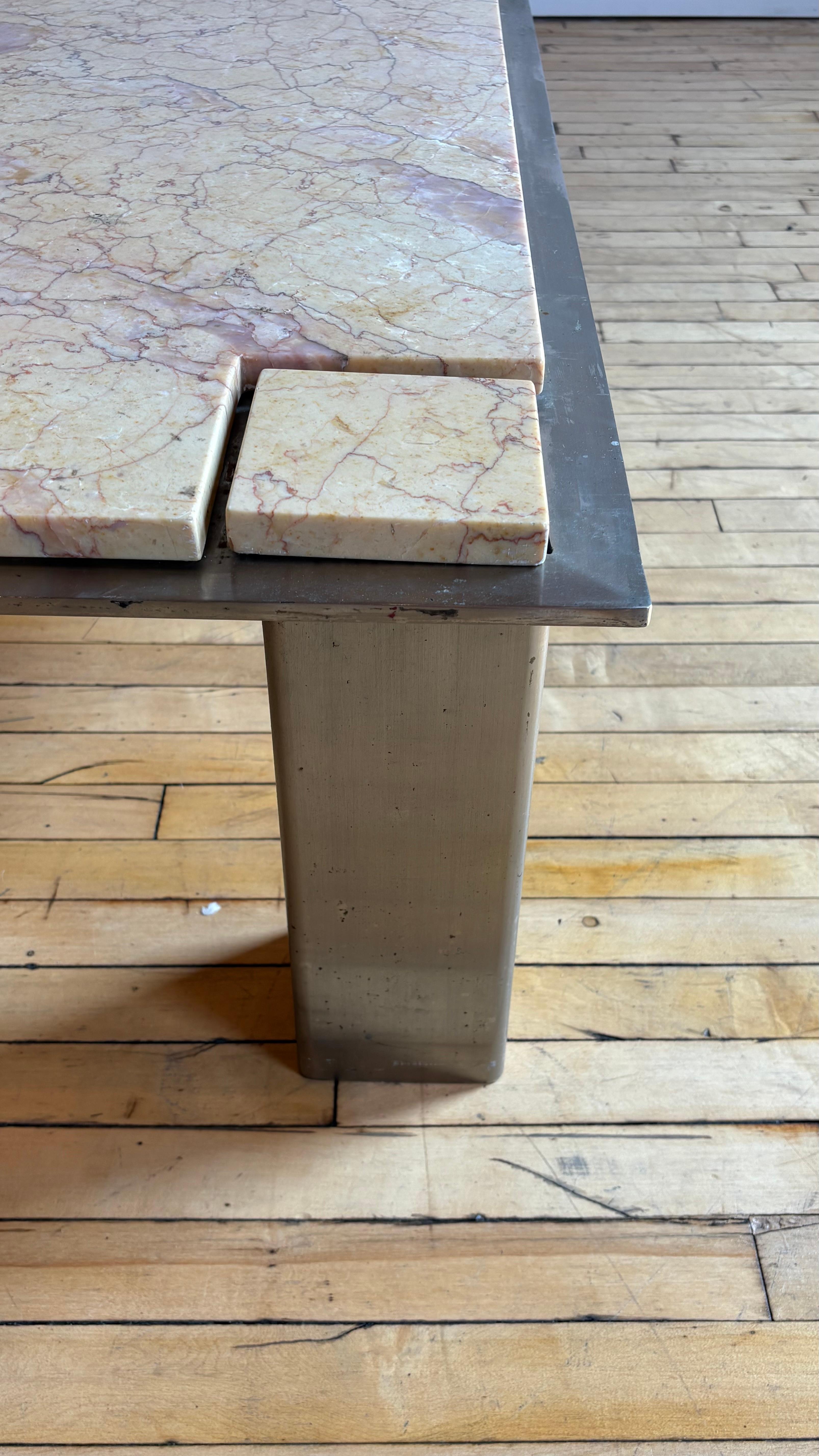 An incredible and mysterious discovery. 

Unknown origins. Could be Roche Bobois from the 1970s. We've never seen anything quite like it. 

Beautiful yellow and pink marble with removable coasters on the corners. Heavy aluminum base. 

Ships from