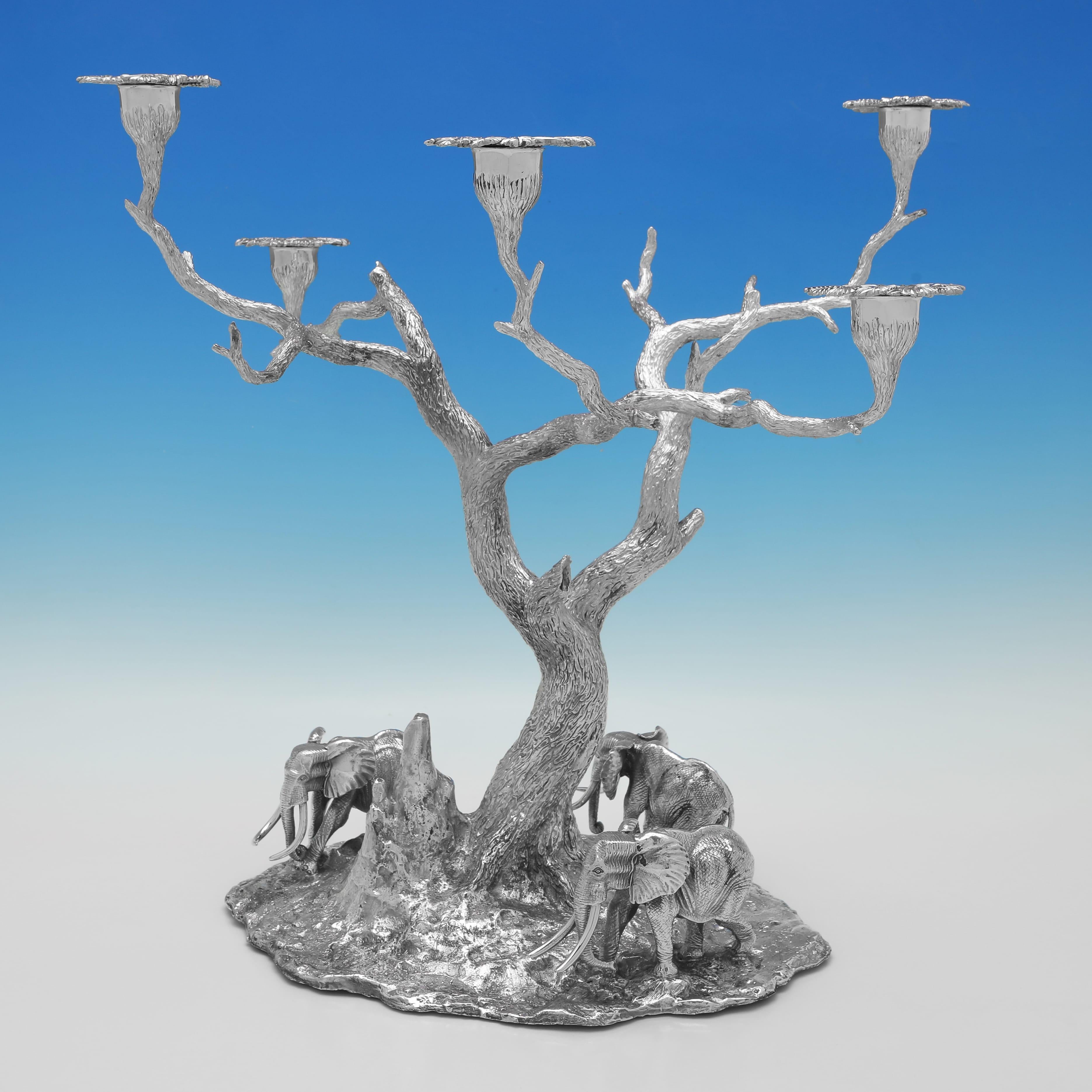 Hallmarked circa 2000 by Patrick Mavros, this quite stunning, Sterling Silver Centrepiece Suite, would make a wonderful African landscape scene on any table, and comprises 9 freestanding elephant models, 4 acacia tree candle holders, and a central