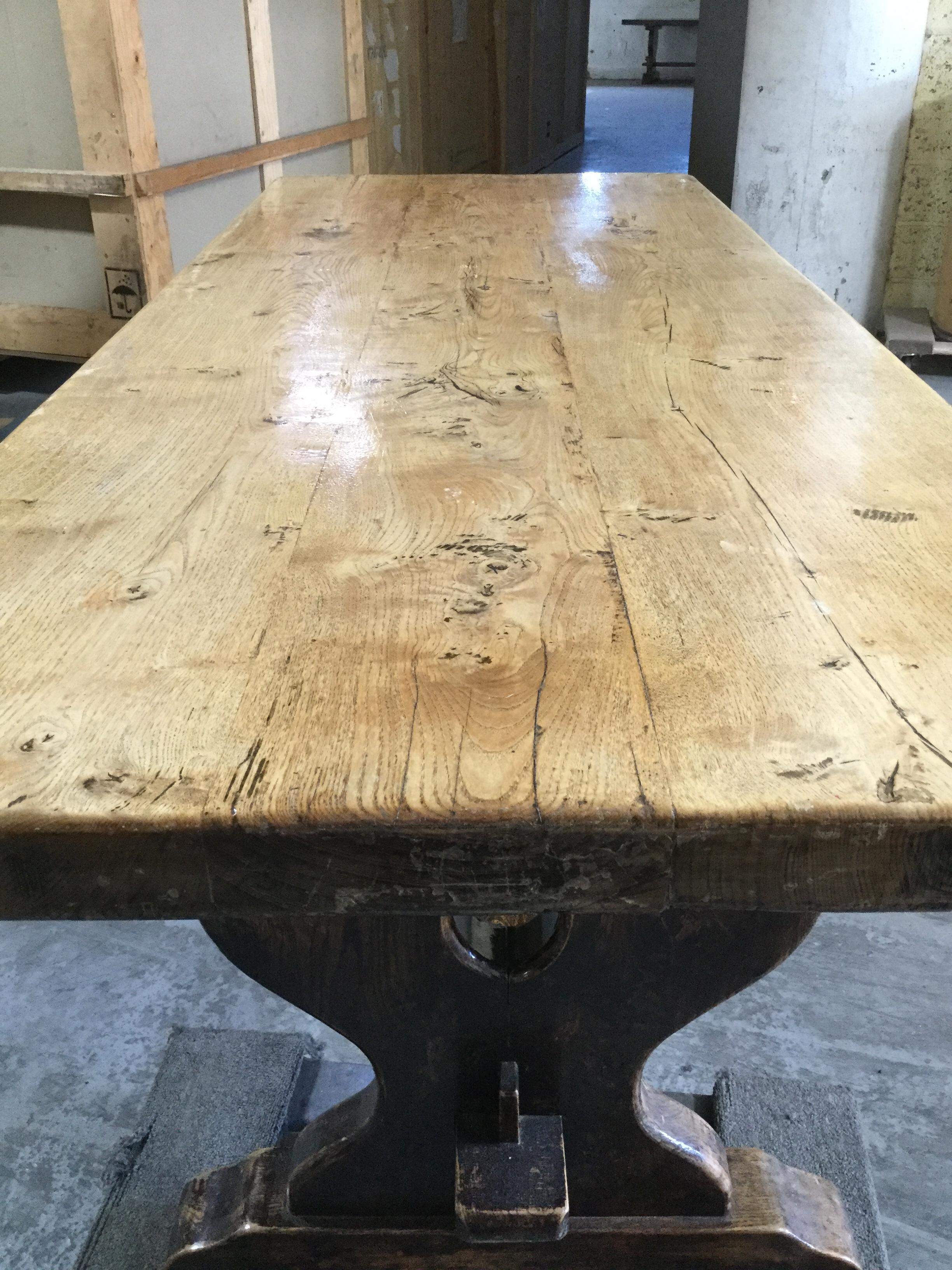 This incredible rustic farm table is completely handmade from planks of elm wood and chestnut having the lighter wood top on top of a pedestal base of darker wood. The top is 2.5 in thick and sits 26.5 inches from floor to bottom of the top. 

 