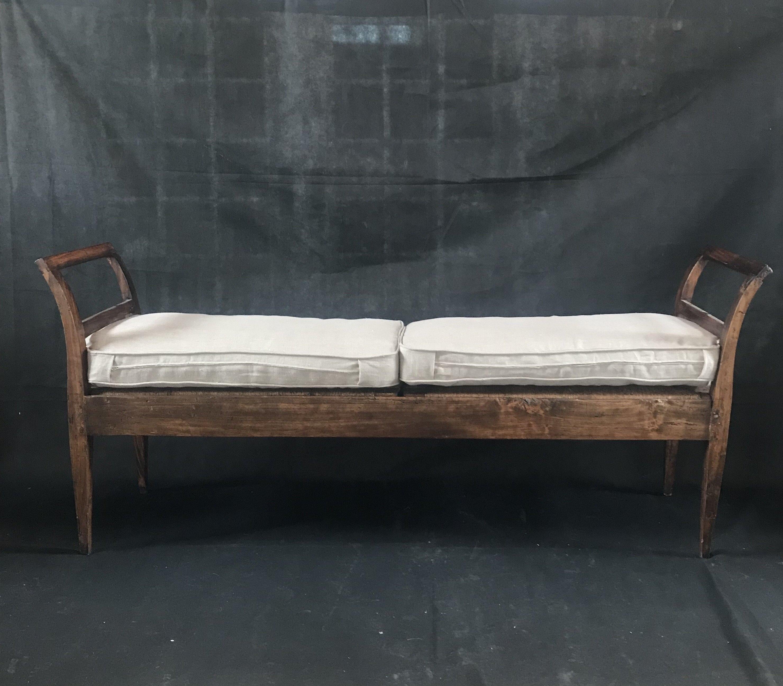 A very long elegant yet rustic 19th century Italian rattan bench from Arezzo, Italy with new beige linen cotton piped seat pillows.
#3033

Measure: H to seat 18”.