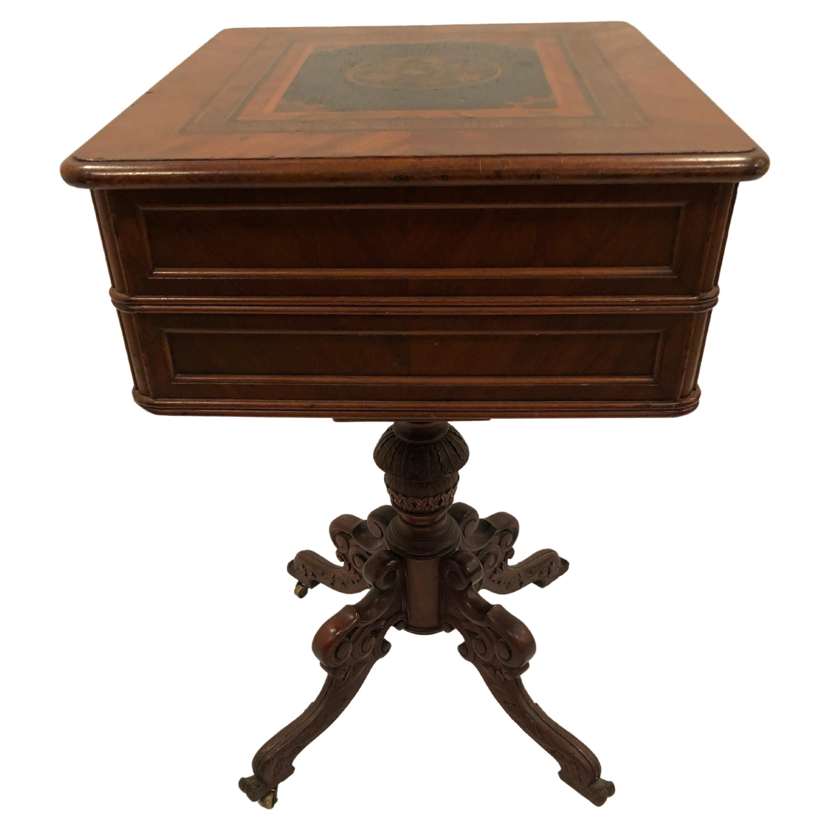 Extraordinary and rare Victorian sewing table that can be used as a gorgeous side table, having marvelous intricate inlay decoration, carved columnar base with four legs, and two drawers. The top drawer pulls out and the top opens to reveal a