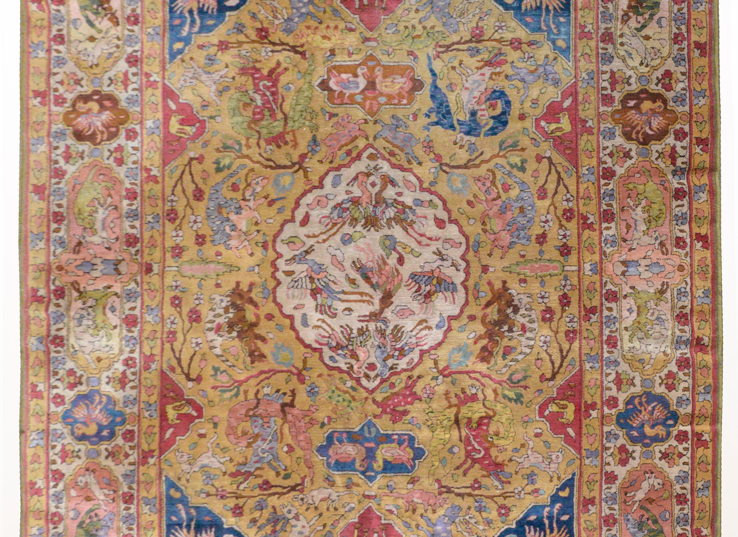 An incredible early 20th century German Tetex rug woven with a traditional Persian Tabriz pattern containing myriad animal including deer, lions, cows, phoenix, boar, and ducks, all woven in indigo, light lavender, coral, green, and white, set
