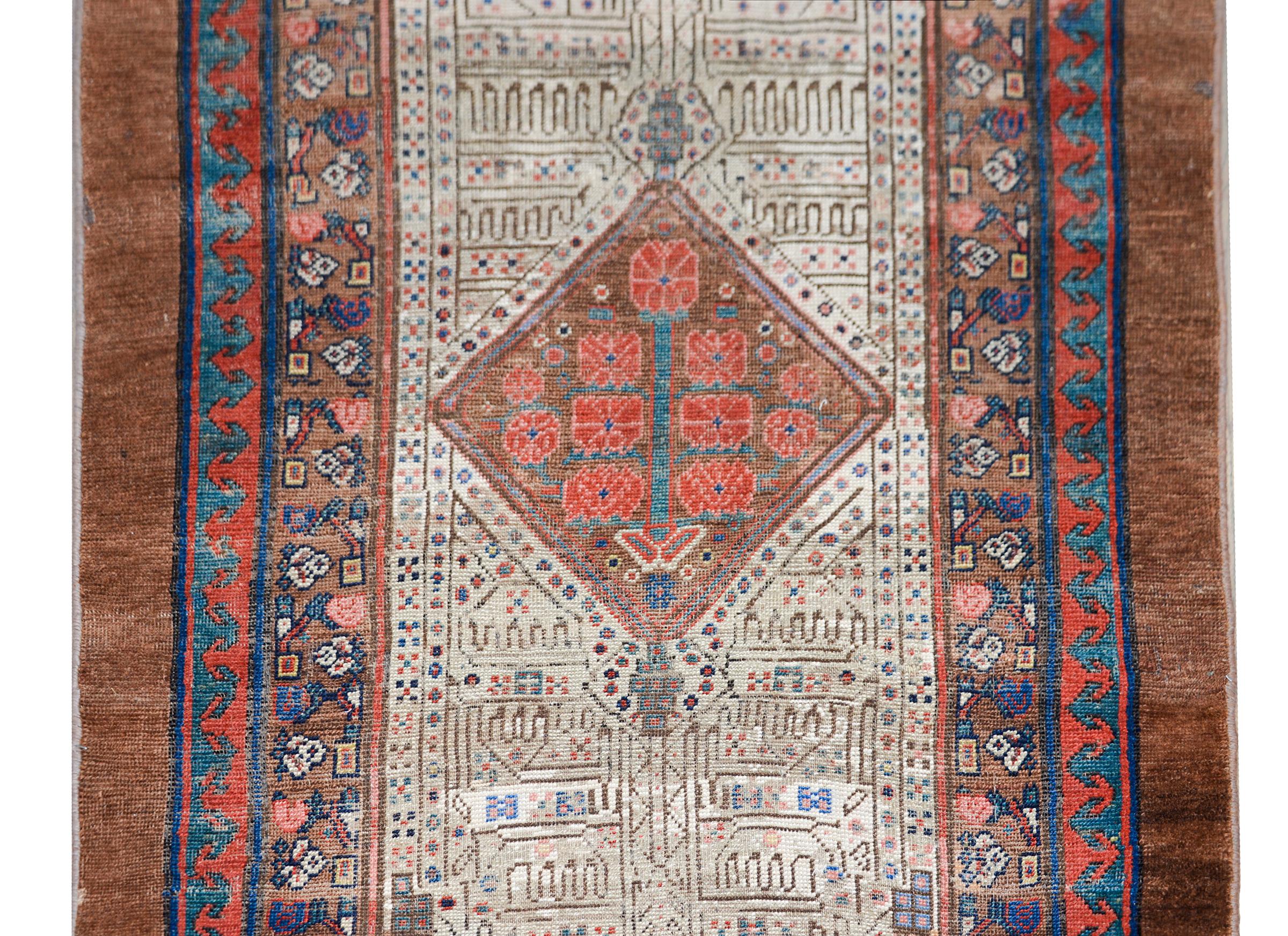 An incredible early 20th century Persian Serab runner with the most wonderful stylized floral patterned field with three large diamond medallions, all woven in crimson, indigo, white, and natural camel hair wool, and surrounded by several petite