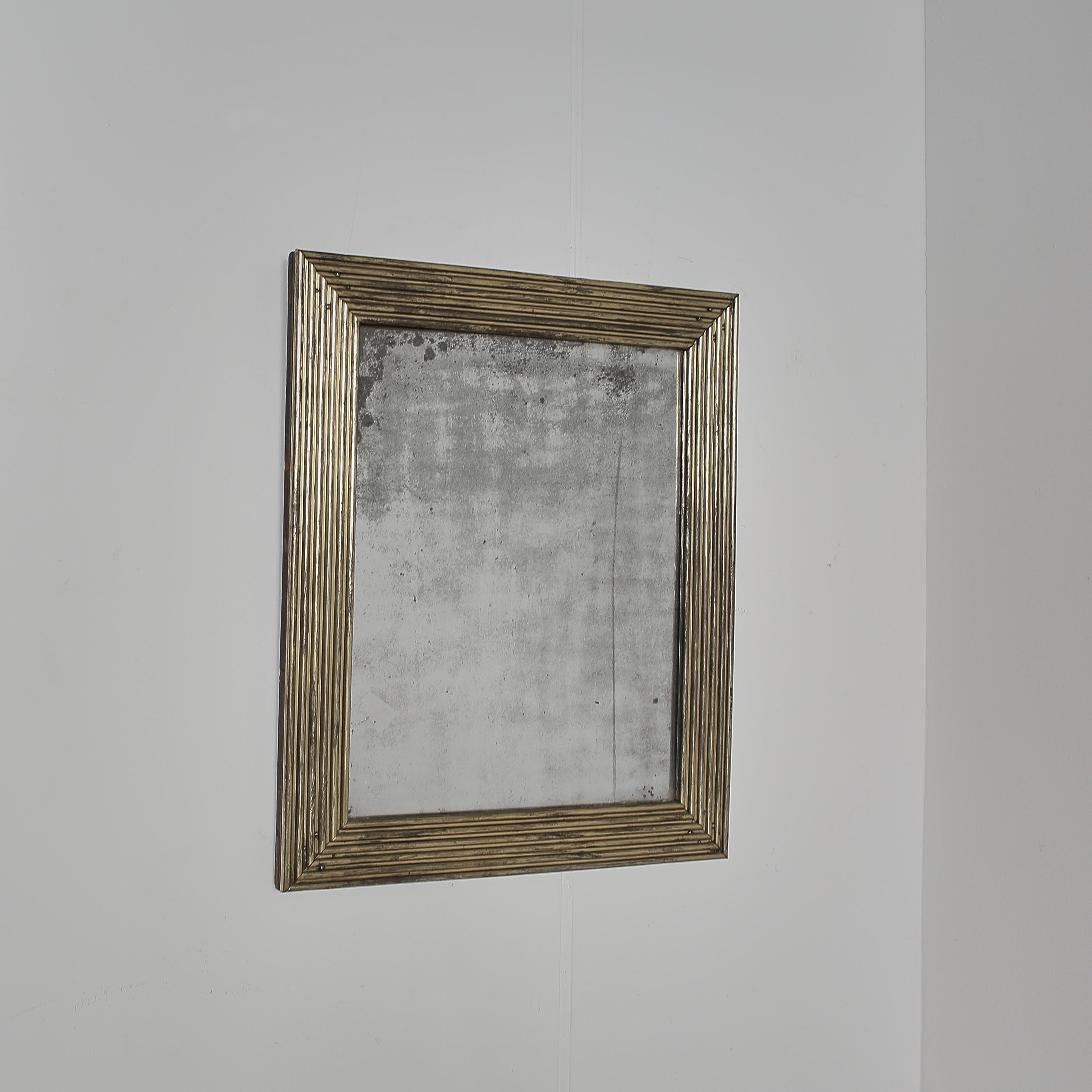 An incredible French bistro mirror from Lyon.

Patinated reeded brass frame with heavily foxed mercury glass plate.