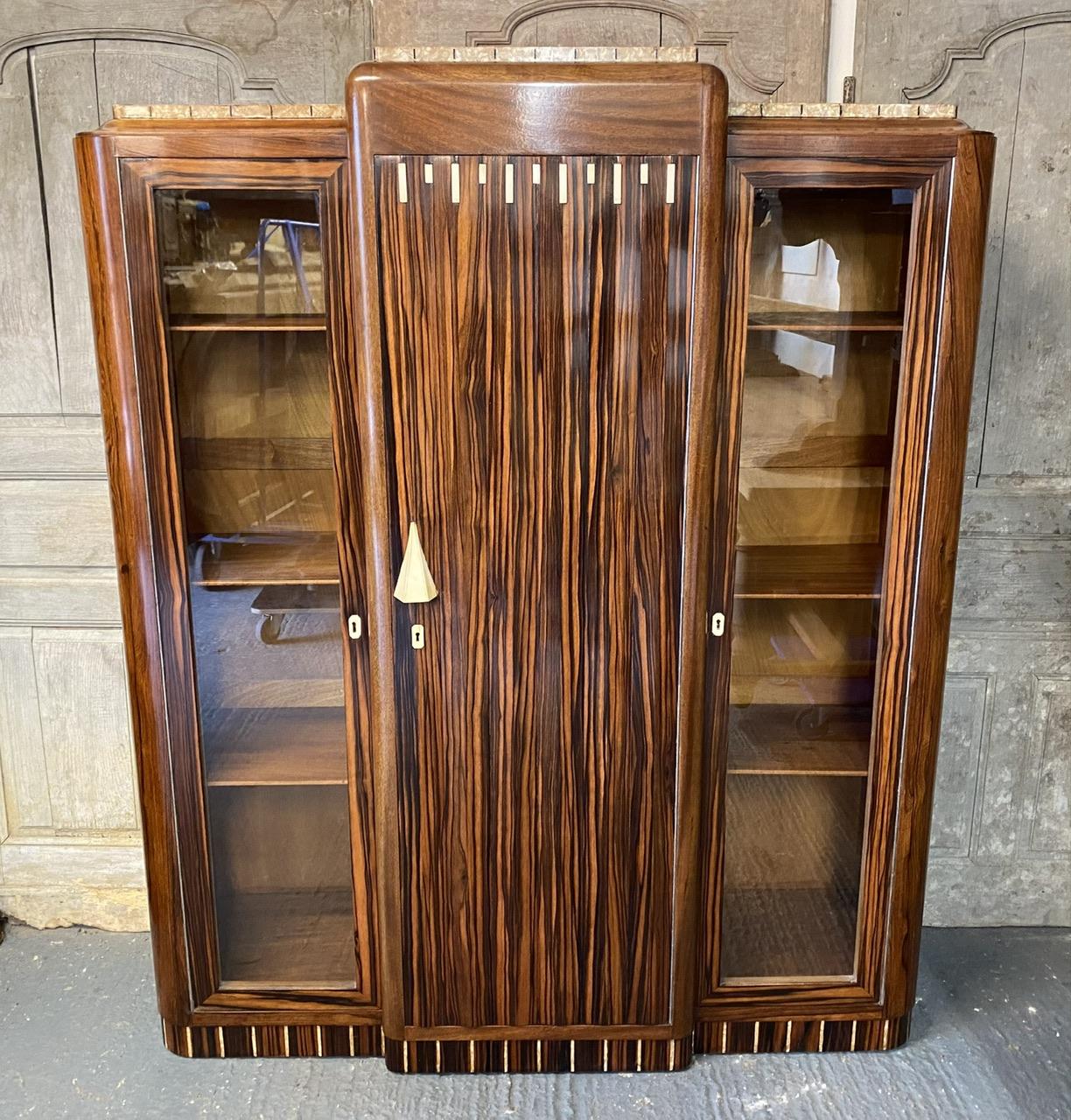 We are delighted to offer this stunning Art Deco Cabinet one of the best we have ever seen. It originates from France and we were lucky enough to find it in Paris. 
The design and quality are second to none and its made of Walnut, Macassar Ebony,
