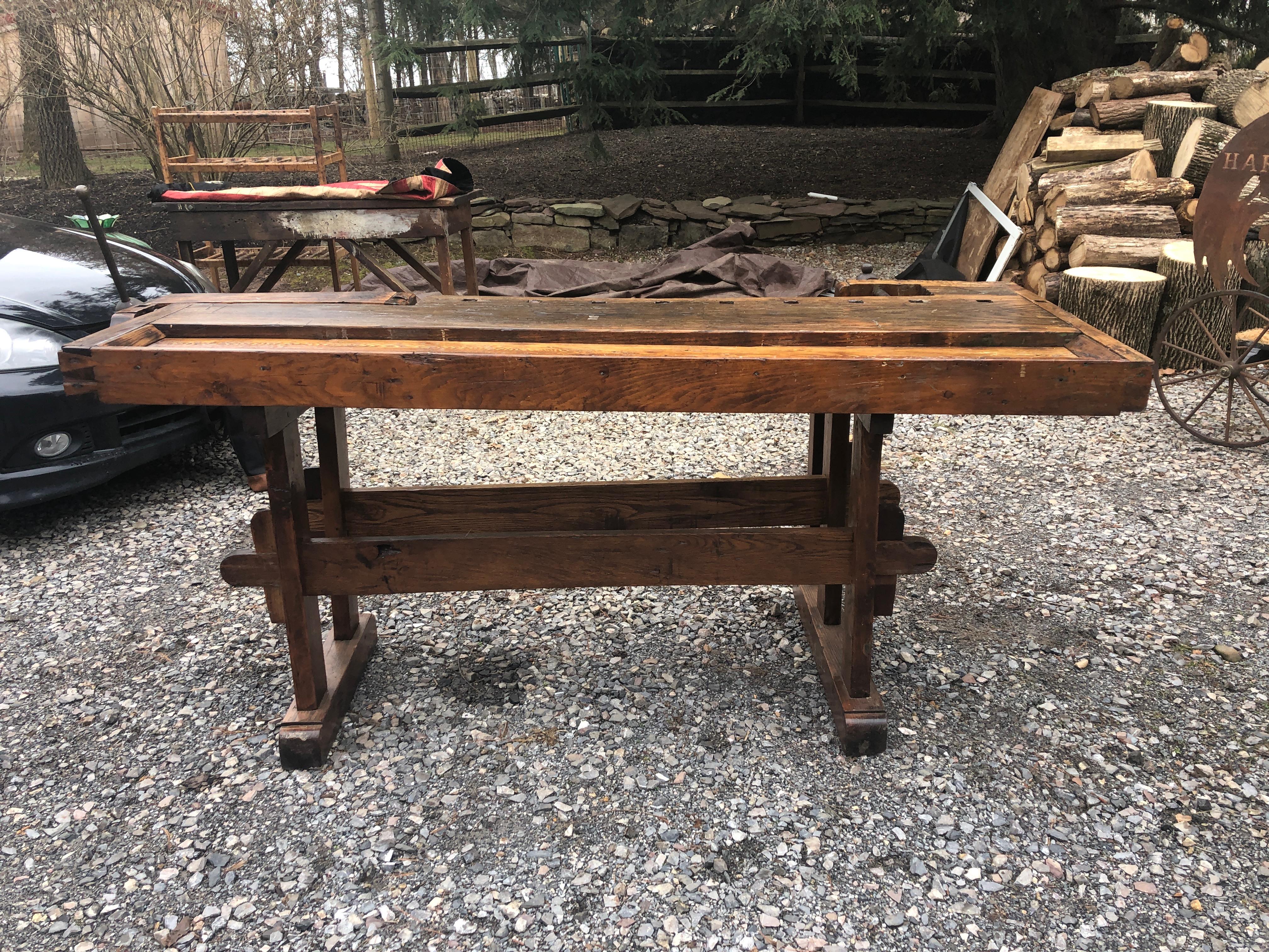 Perfect as a display piece or handsome console or bar, this is a one of a kind very large masculine oak work bench from Vermont having original vices in working condition. Beautiful construction with dovetailing and each piece of wood hand selected