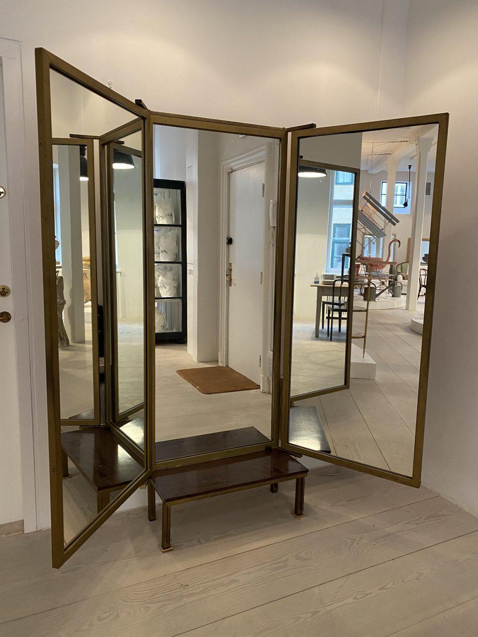 Incredibly handsome and elegant vintage 3-wing dressing mirror from circa 1960s-70s Italy. This gorgeous piece is made of quality metal frames painted with a dark patinated gold finish, that rests on a sleekly designed base including a practical